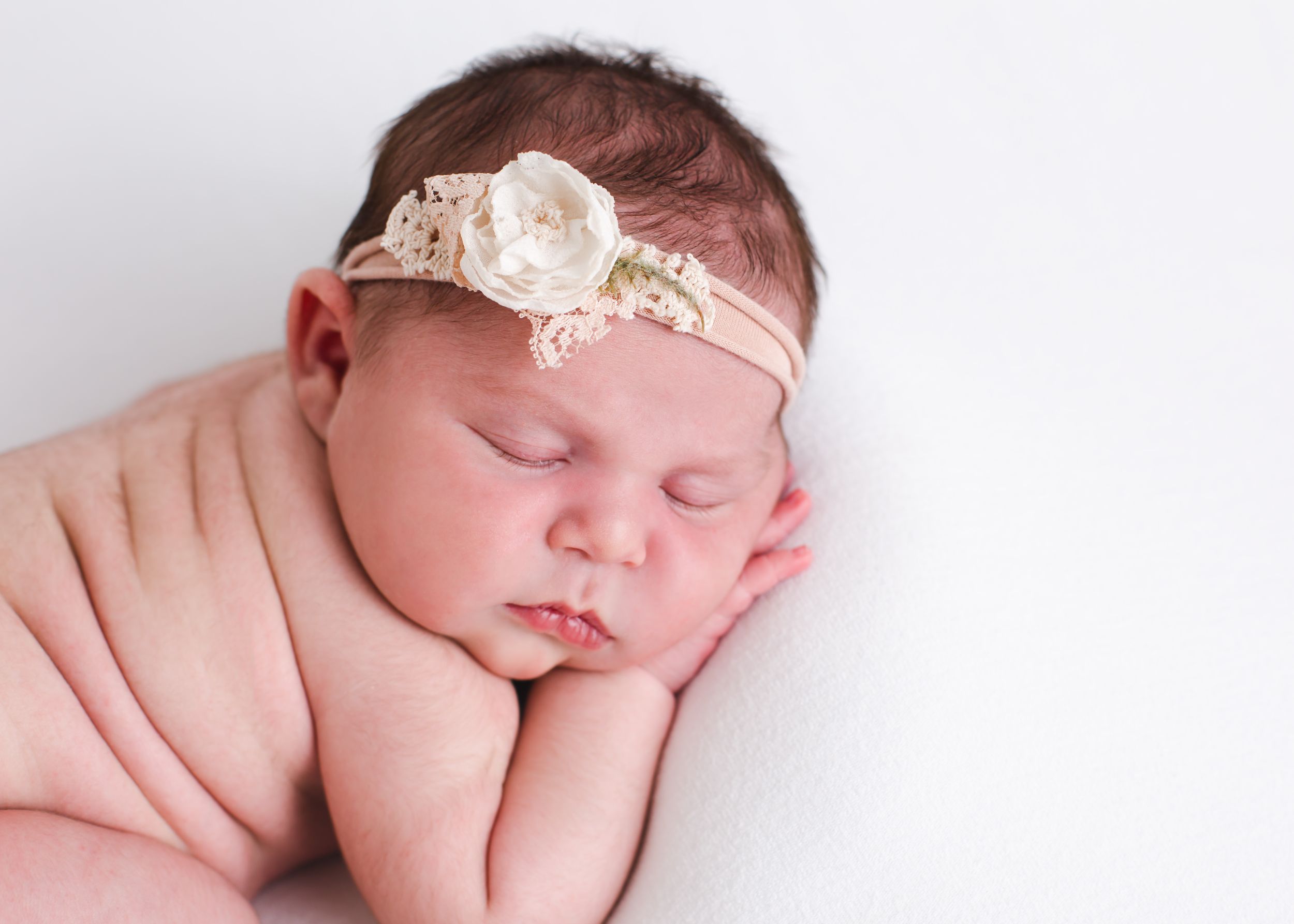 nebworn posed on baby blanket with headband - penticton bc newborn photography