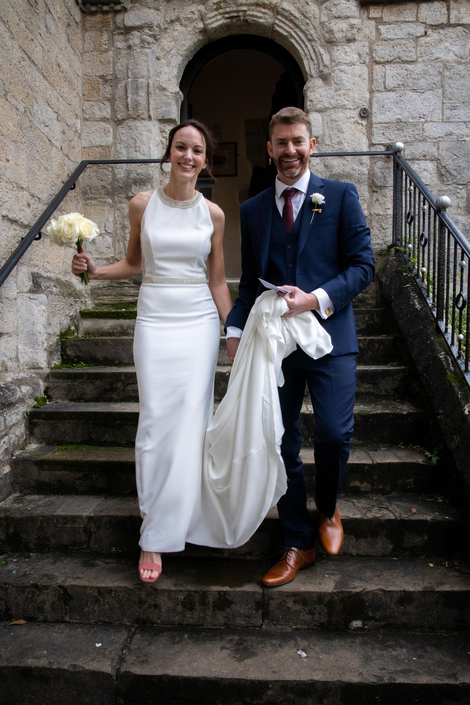 Bride and Groom walking down stairs at The Archbishop's Palace