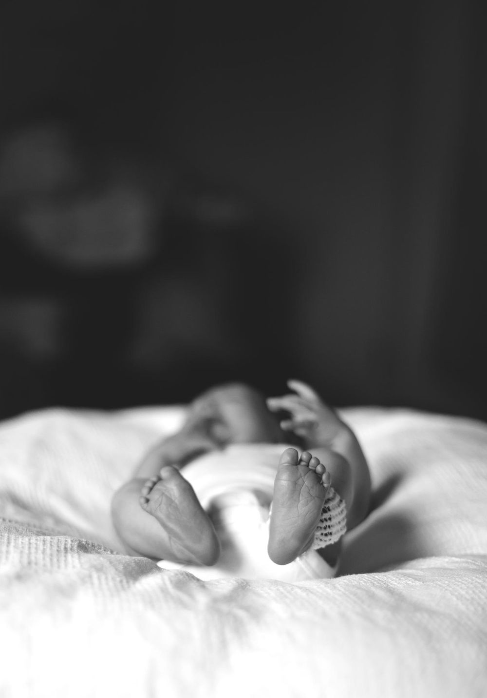 newborn boy in his diaper and laying on the hospital bed