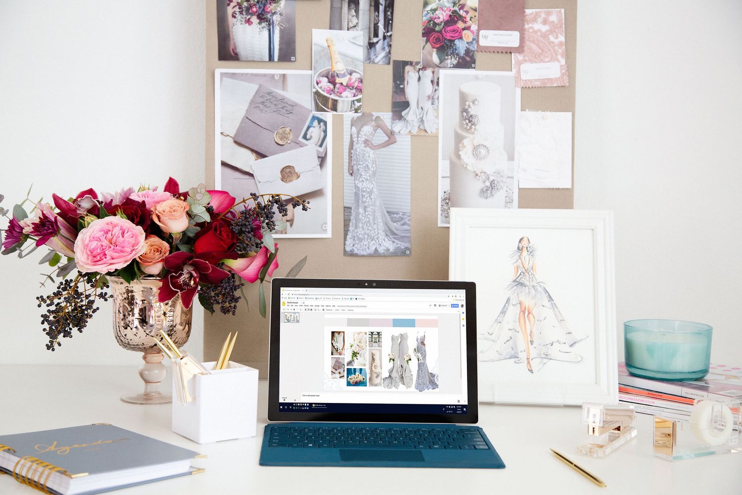 Feminine office setting. Desk with laptop and flowers.