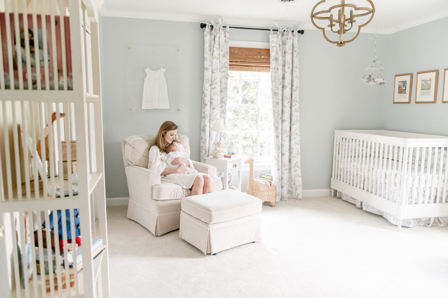 New mother rocks her baby boy in the Peter Rabbit themed nursery