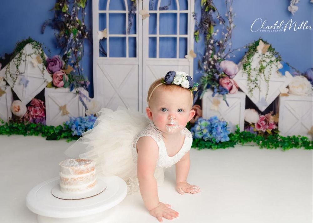 baby girl eating crawling and eating cake
