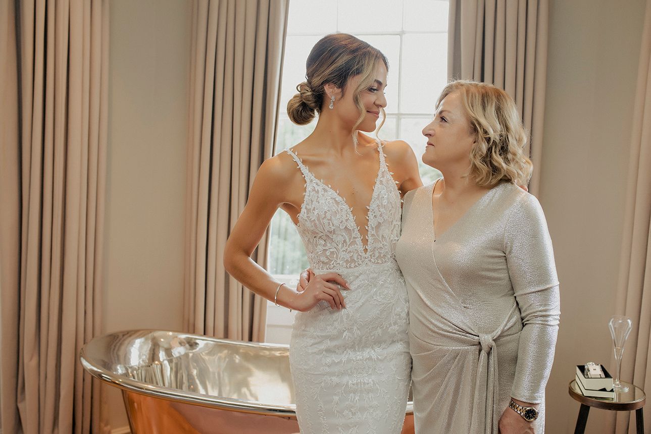 Bride wearing Made With Love dress, embraces mother at Bingham Riverhouse, Richmond London
