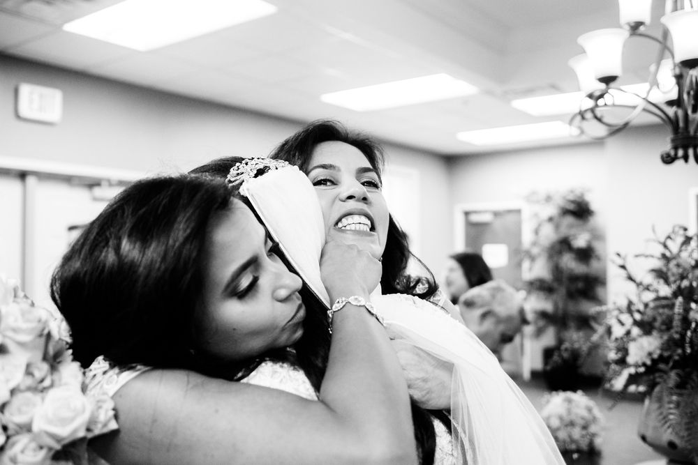 Bride hugs bridesmaids after ceremony