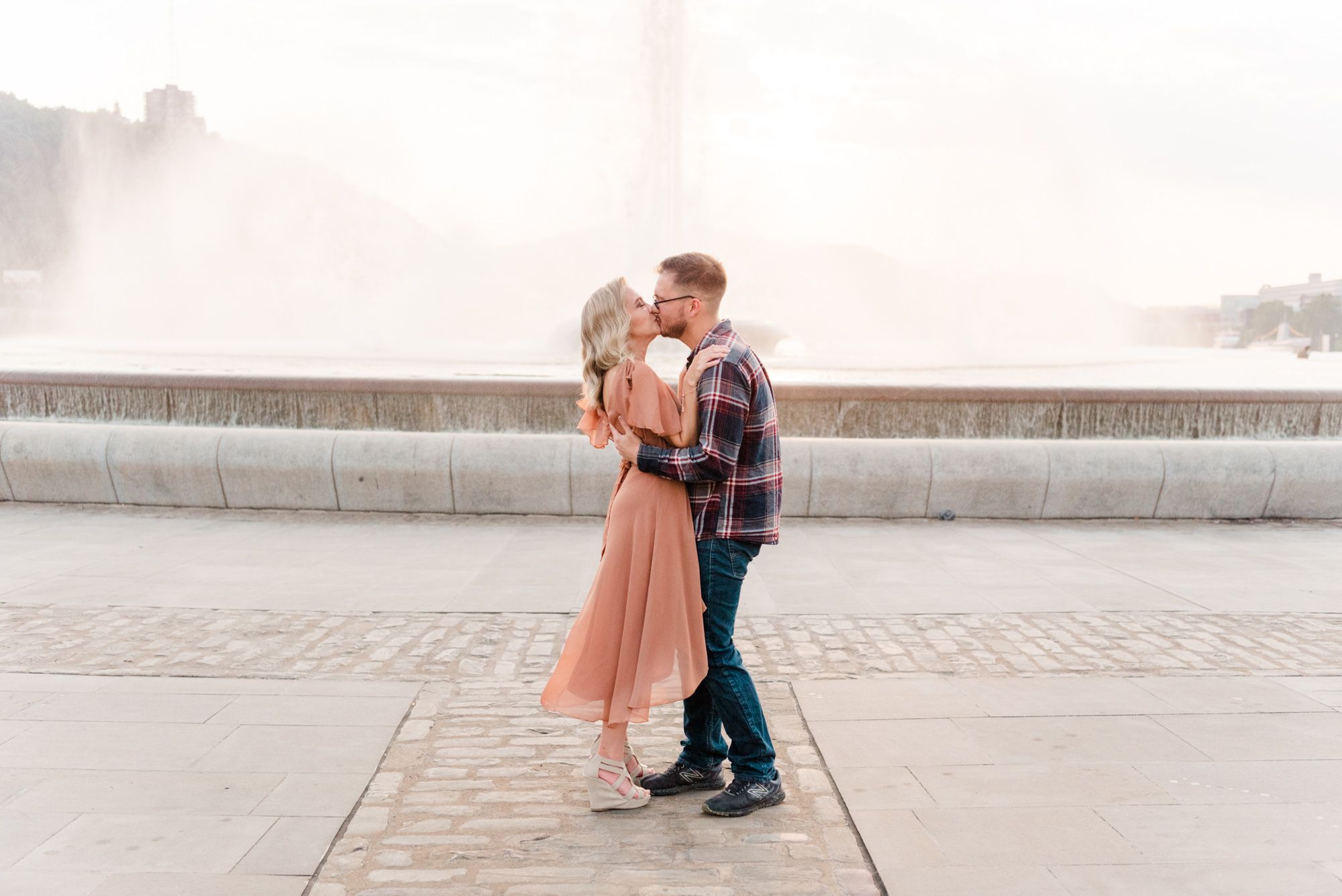 Surprise proposal at sunset in front of fountain Point State Park in Pittsburgh, Pennsylvania