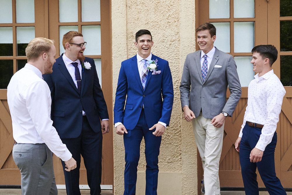 groom and groomsmen laughing in front of garage at Lord Mansion in Olympia, WA