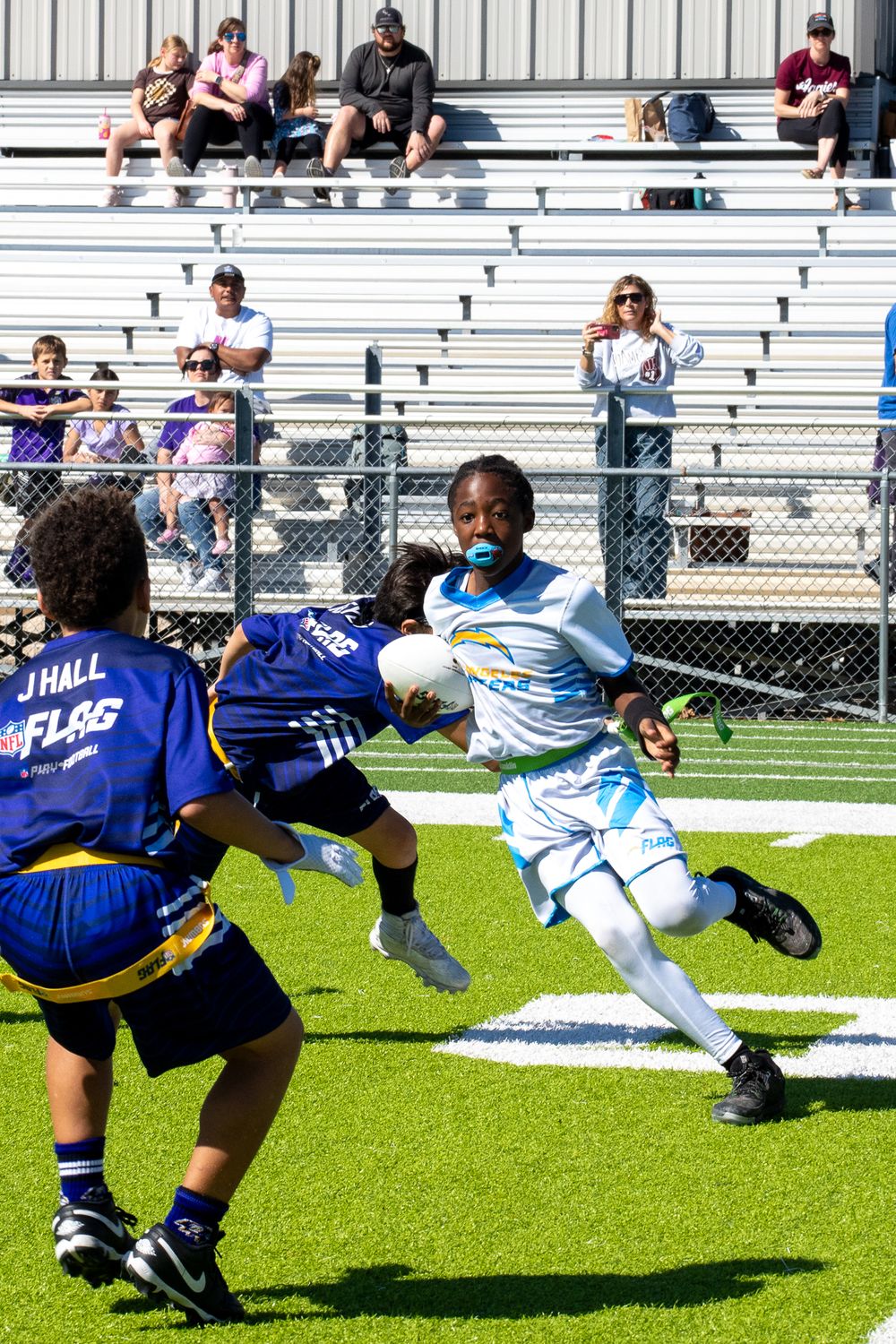 young man carrying football in Bryan, Texas