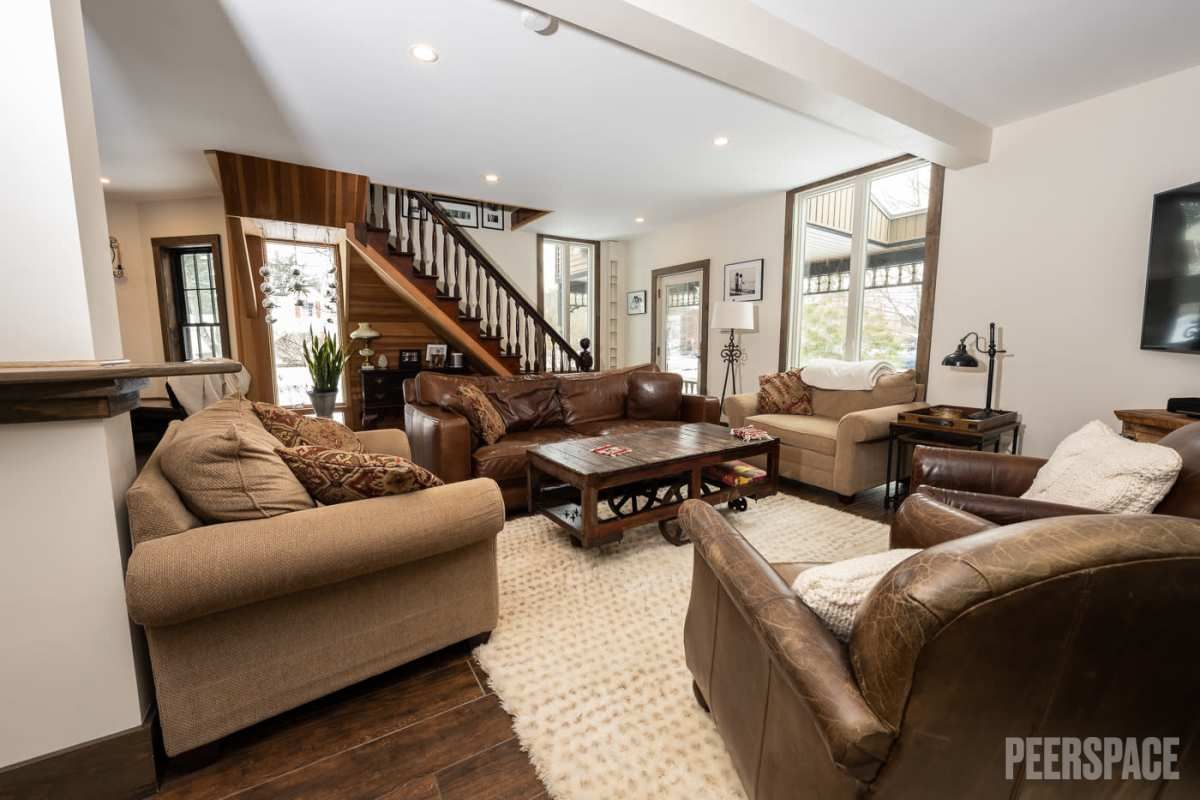 Open concept living room featuring comfortable sectional seating and traditional decor.