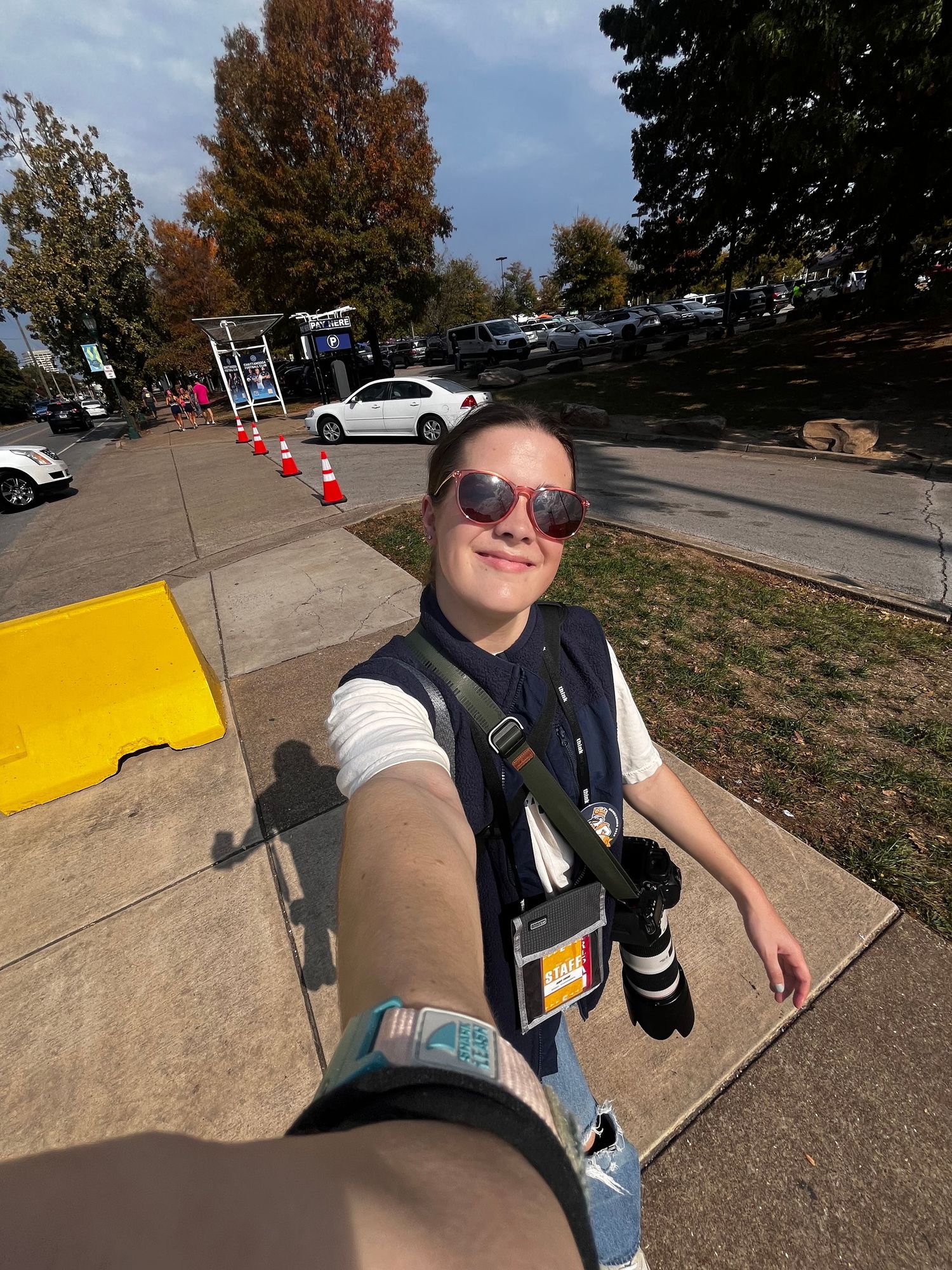 A skateboarding sequence showing progression of tricks and jumps on a sloped sidewalk path during a sunny autumn day.