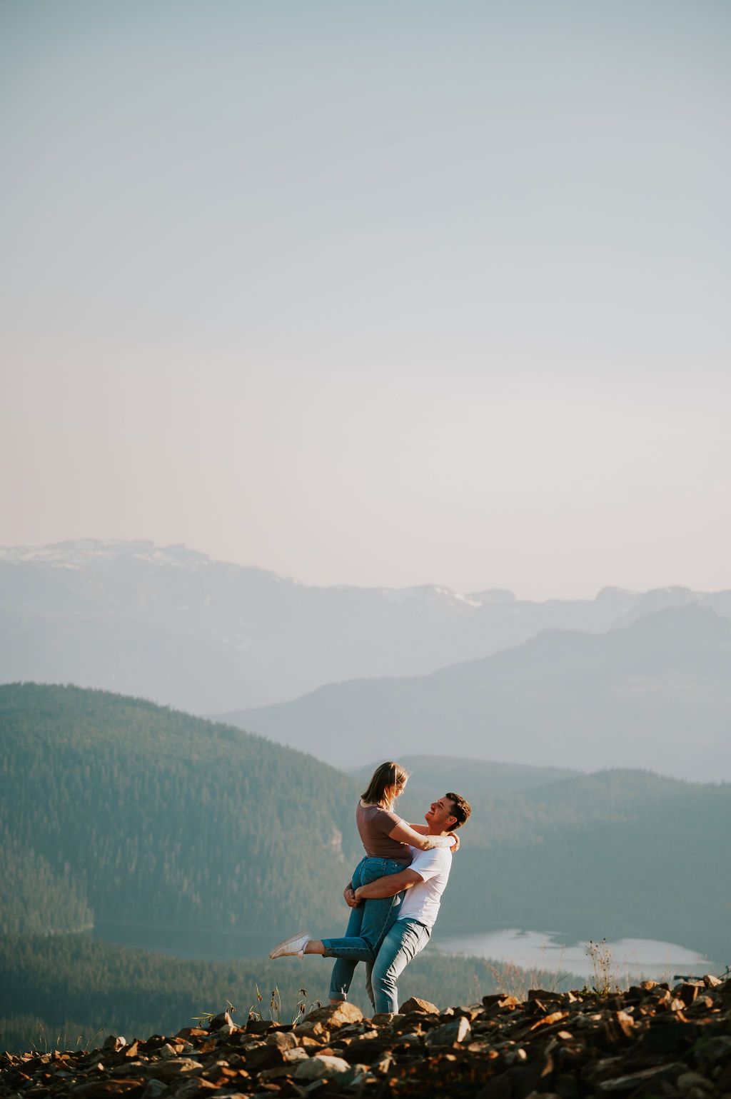Couple spinning on the top of mountain Mt Washington chairlift kissing Vancouver Island. Photography by Photographer Soulfull Photographs