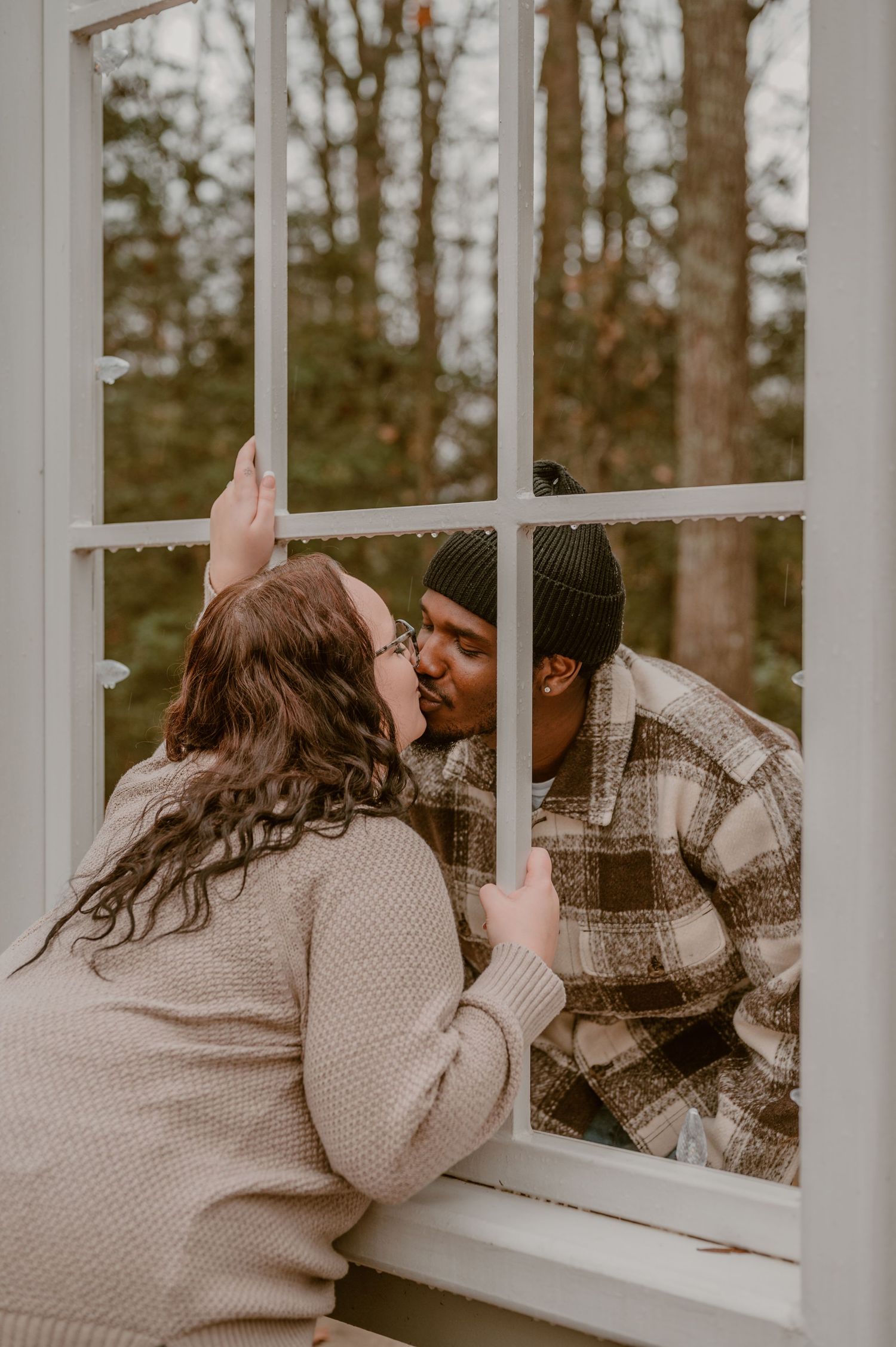 Romantic couple sharing an intimate, cute moment through a divided light window pane. photo by Samantha Campbell imagery
