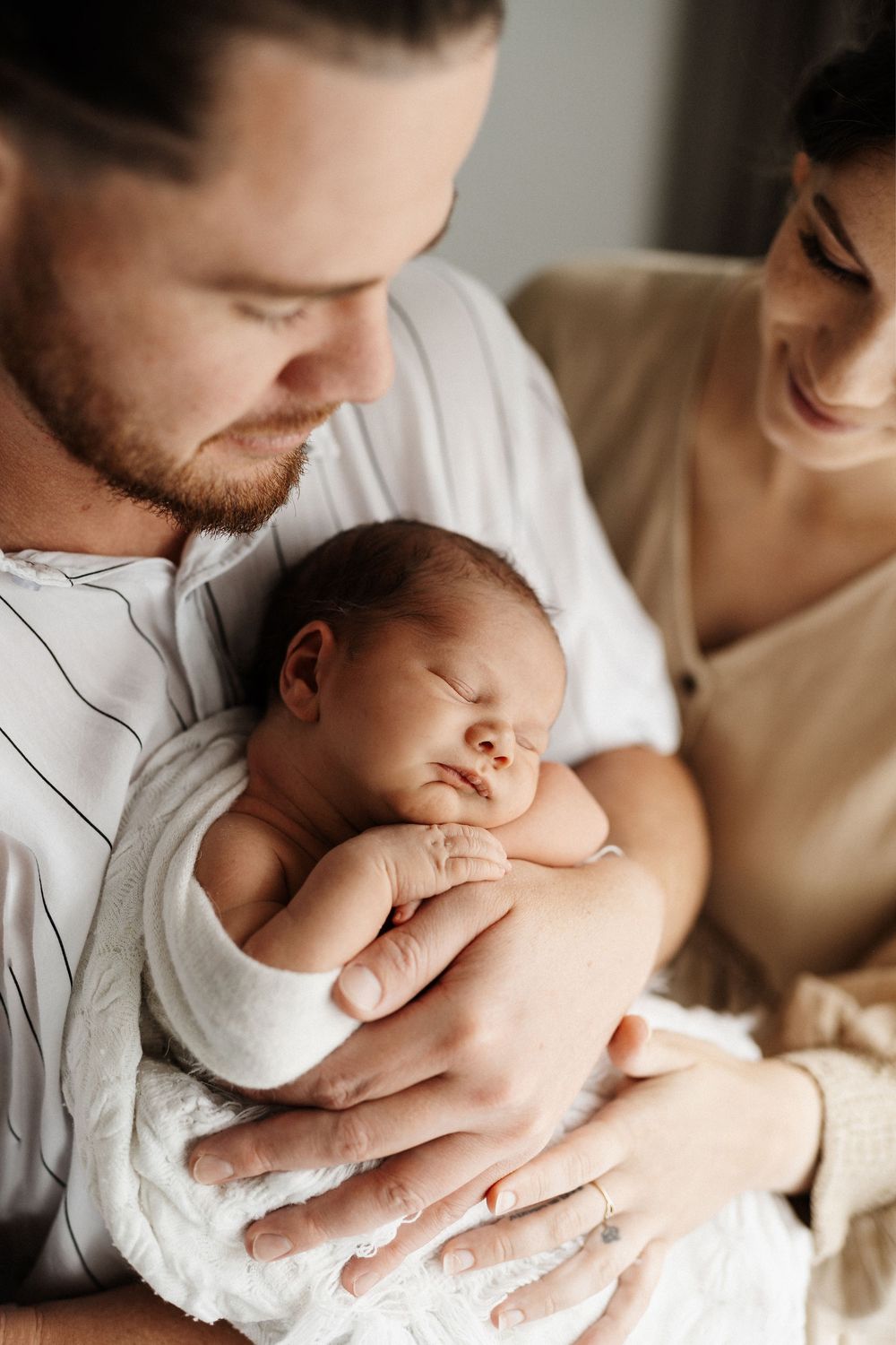 Close up shots of a newborn baby being held with gentle care and love.