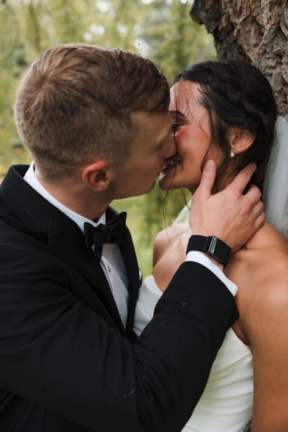 Romantic sequence of wedding couple sharing a tender kiss against a natural outdoor backdrop.