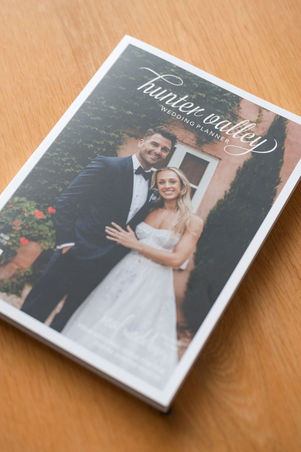 A wedding photo album cover featuring a bride and groom portrait on a hardbound book.