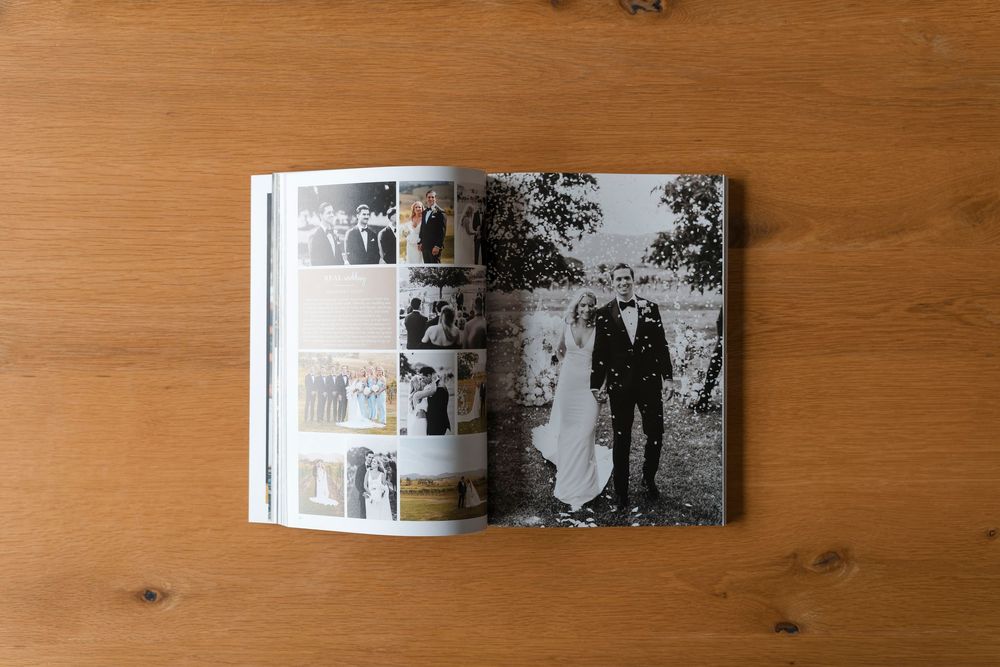 Open wedding photo book displaying various ceremony and couple photos across a two-page spread.