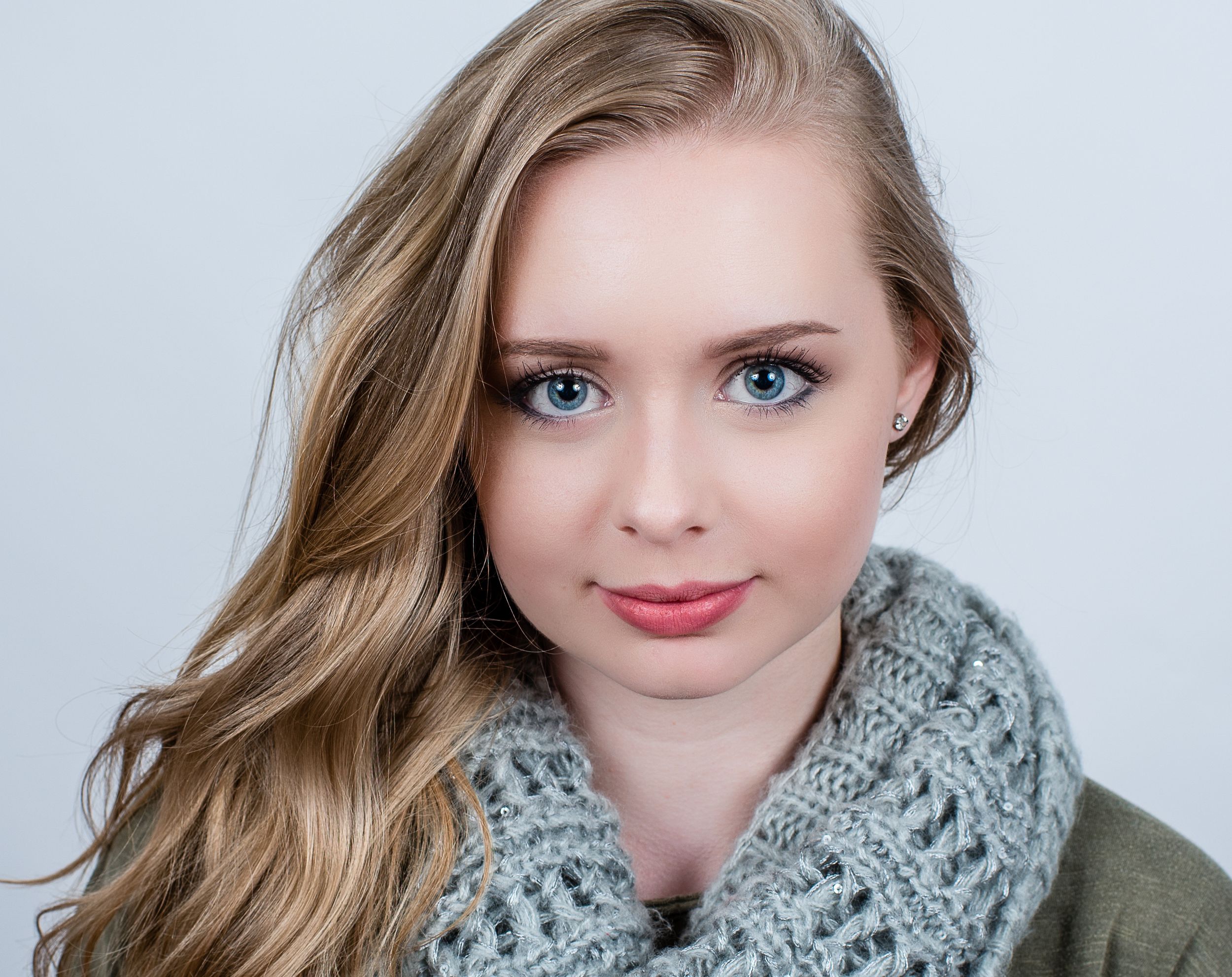 Professional beauty portrait series showing close-up shots with soft lighting and light gray knit scarf.
