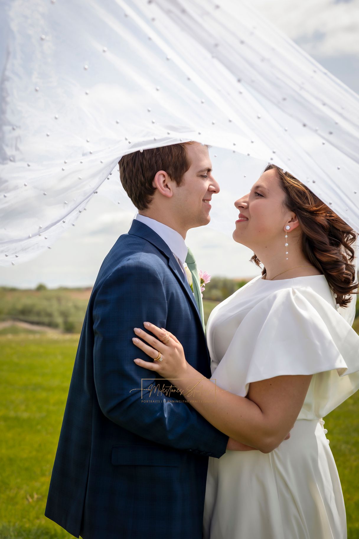 bride and groom looking at each other under veil