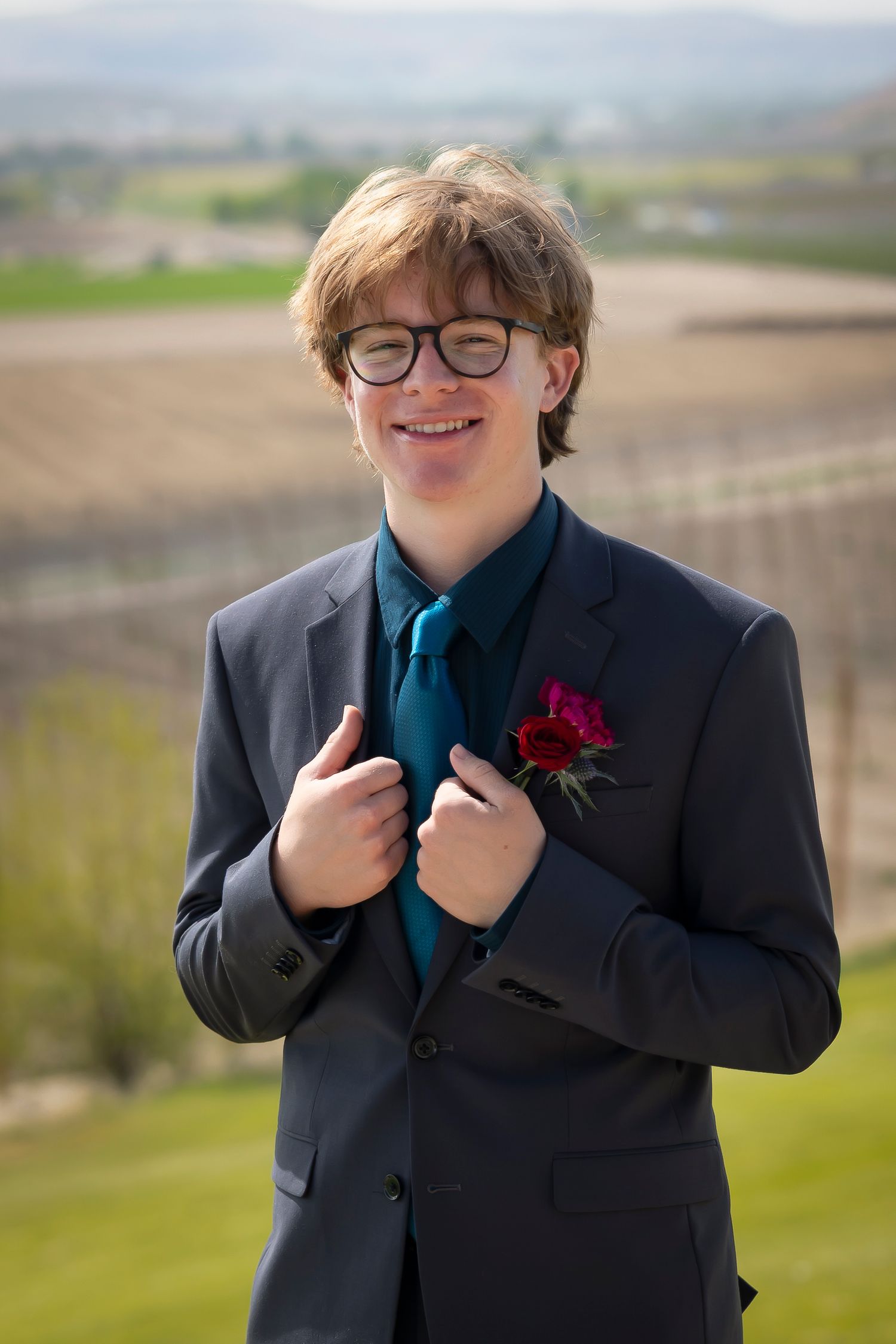 Groom wearing Gray and holding lapel at Garman Hill