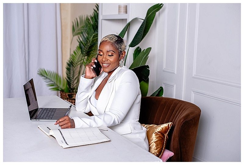 West Palm Beach personal branding photograph of a woman sitting at her desk with a laptop, showcasing a professional work environment.