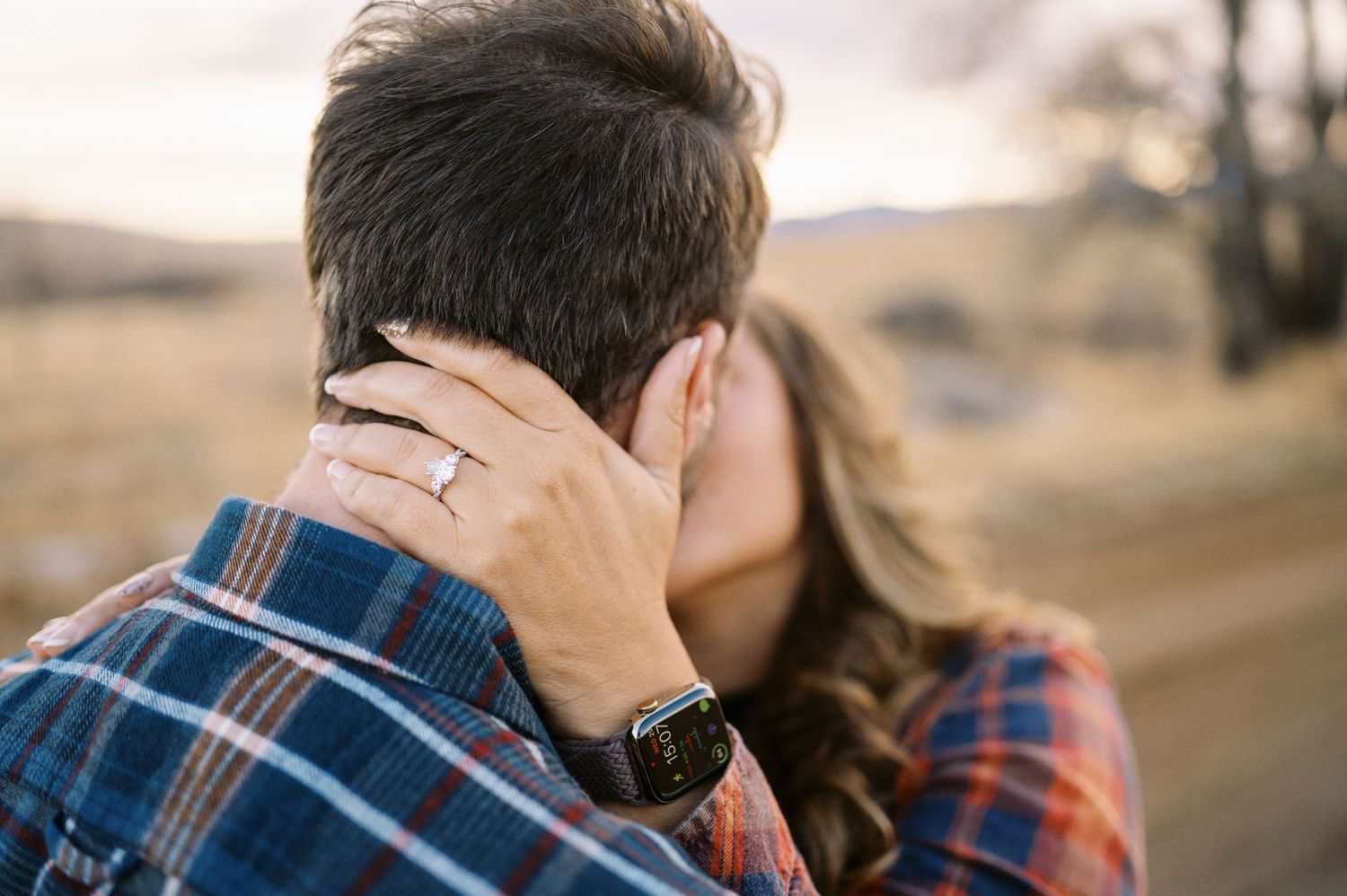 Close-up shot of an intimate moment between a couple outdoors.