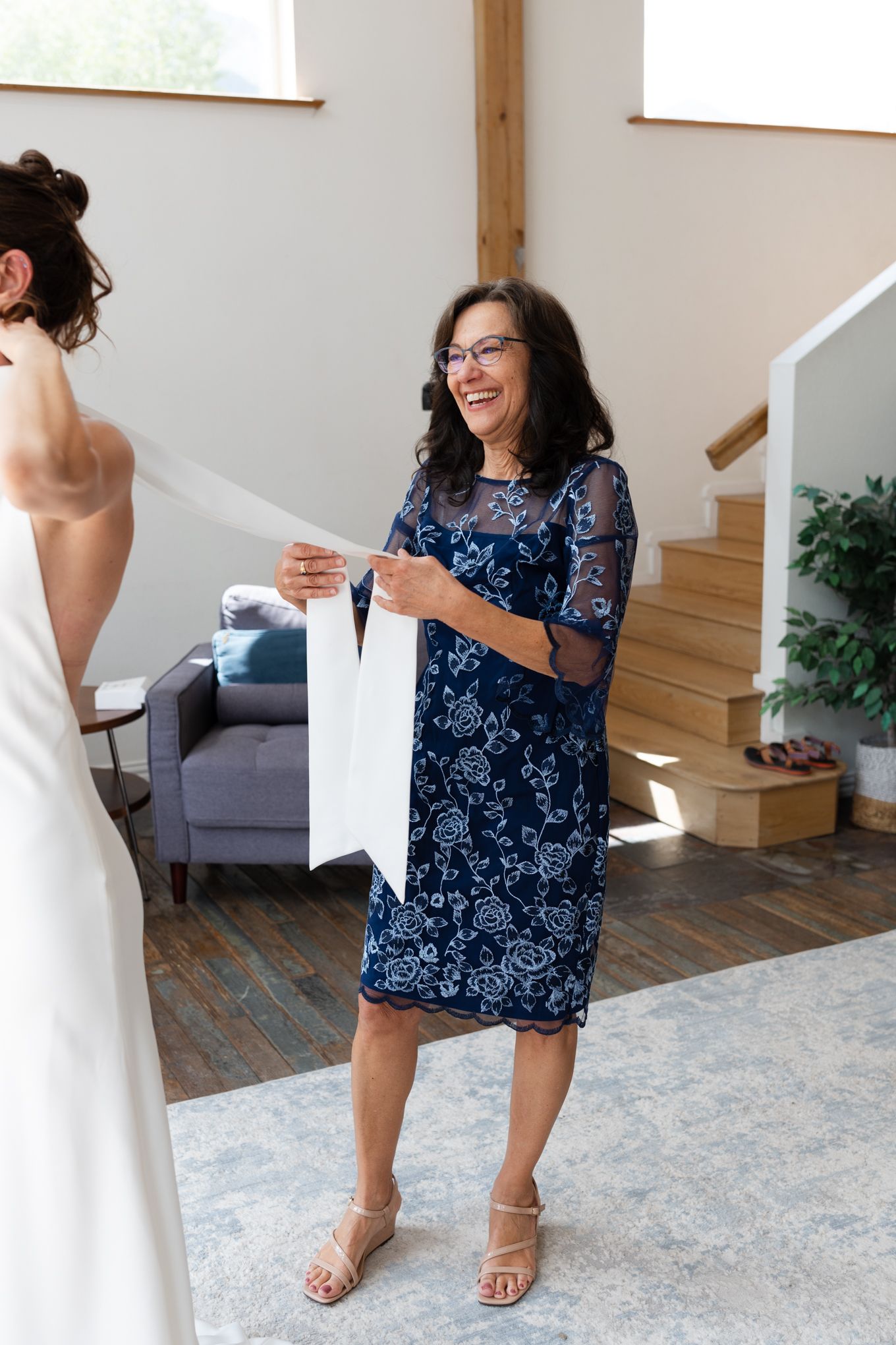Wedding preparation scene with white dress and blue floral pattern dress.