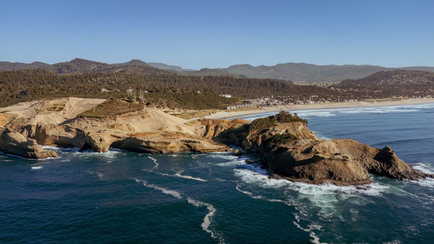 Photo of the Oregon Coast, beach, ocean, mountains, gorgeous view from the sky.