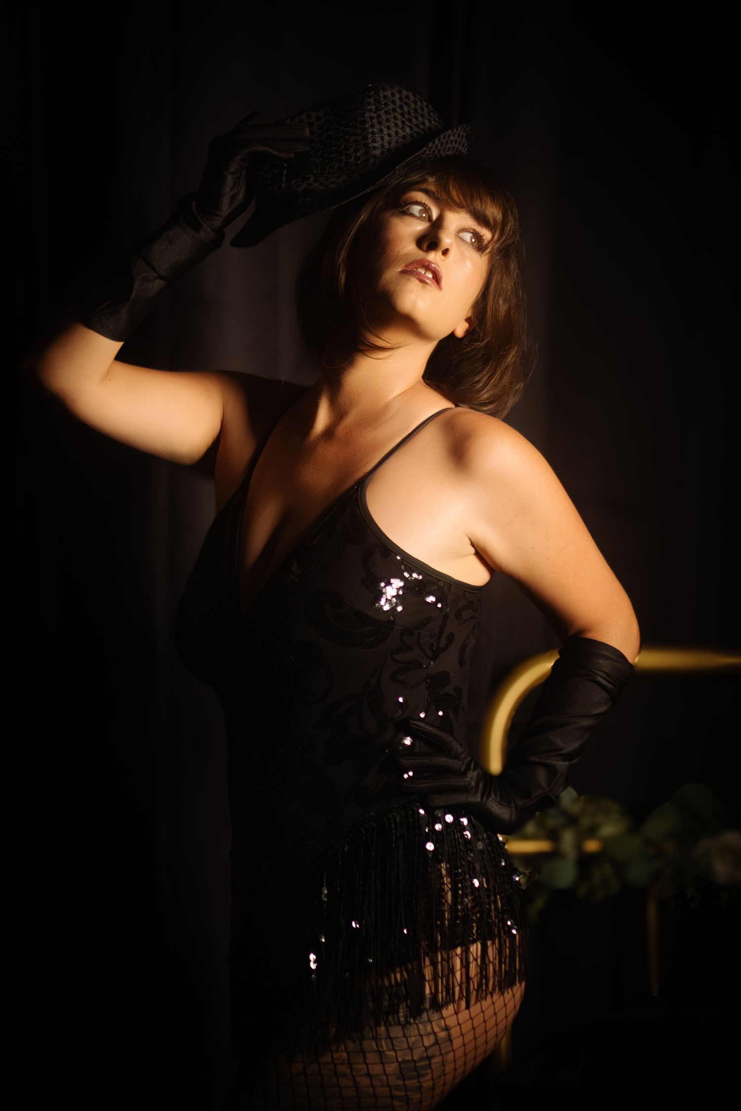 Empowered boudoir portrait in Fort Worth studio featuring vintage cabaret styling, spotlighting sensual strength and inner fire.