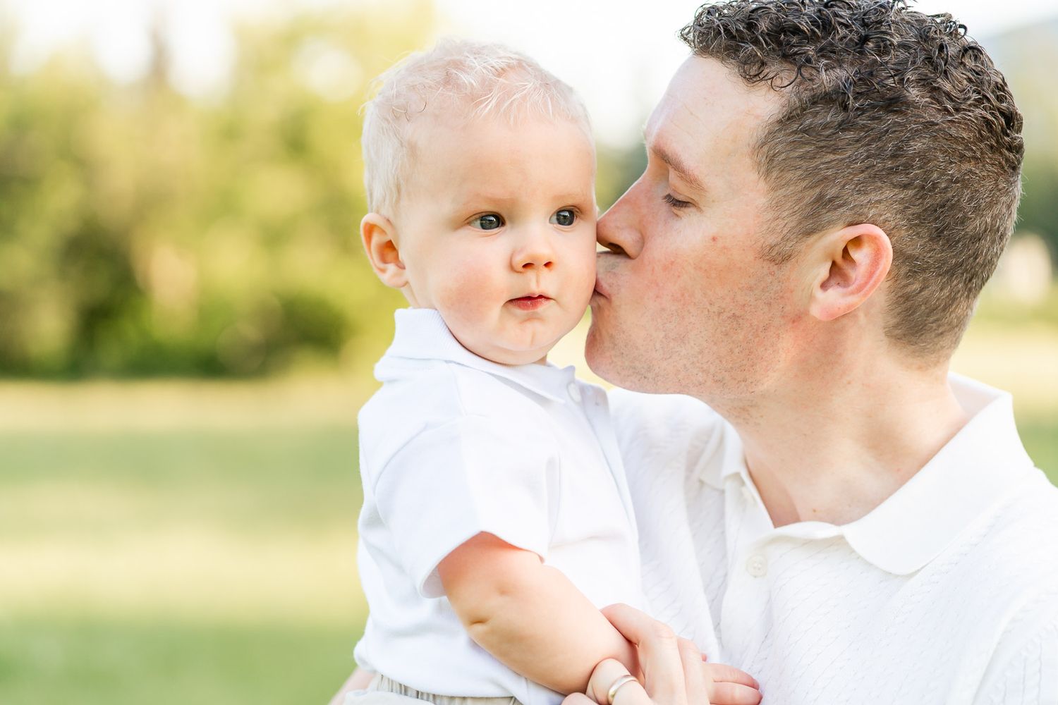 Dad kisses son in North Bend park.
