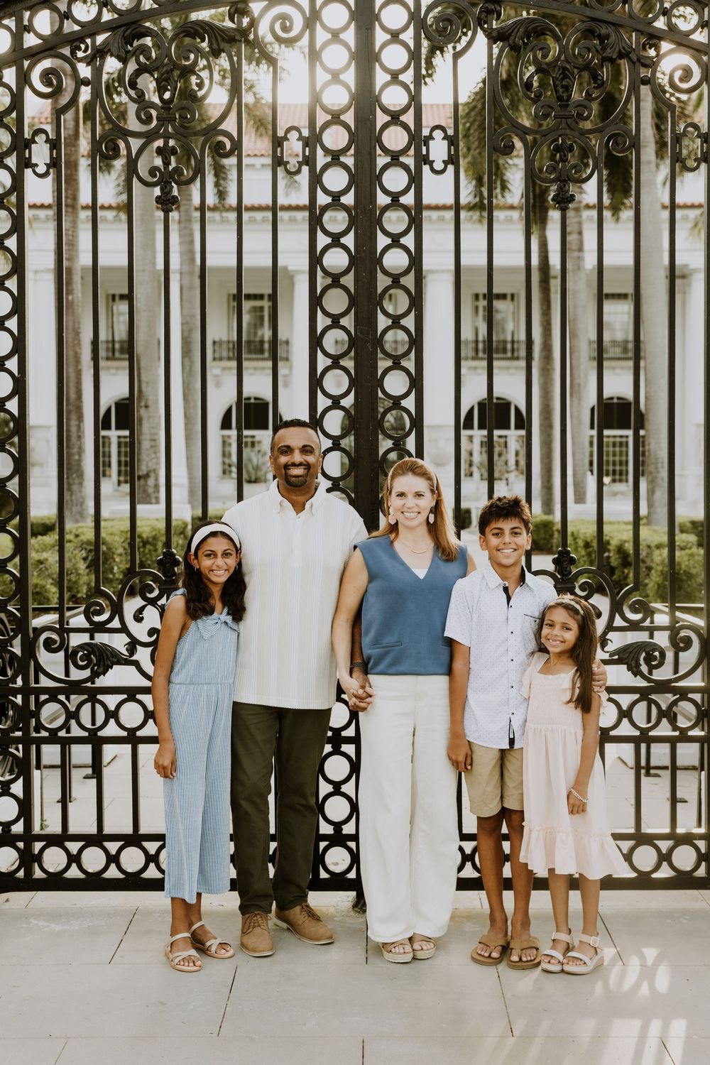 Golden hour summer family photos captured by Lindsay McDow Photography in front of Flagler Museum on Palm Beach Island