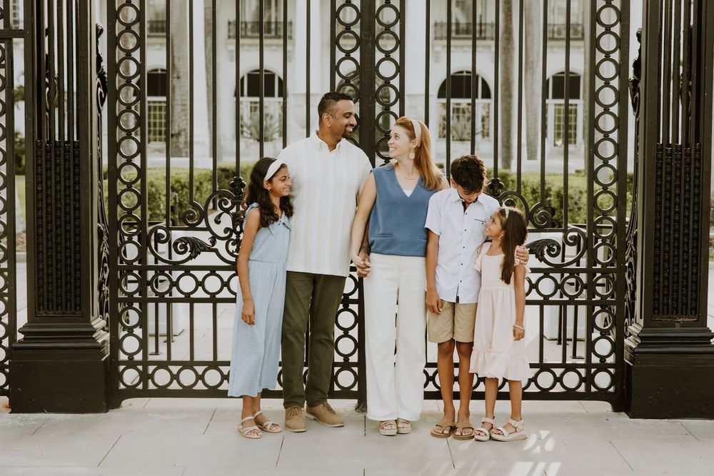 Golden hour summer family photos captured by Lindsay McDow Photography in front of Flagler Museum on Palm Beach Island