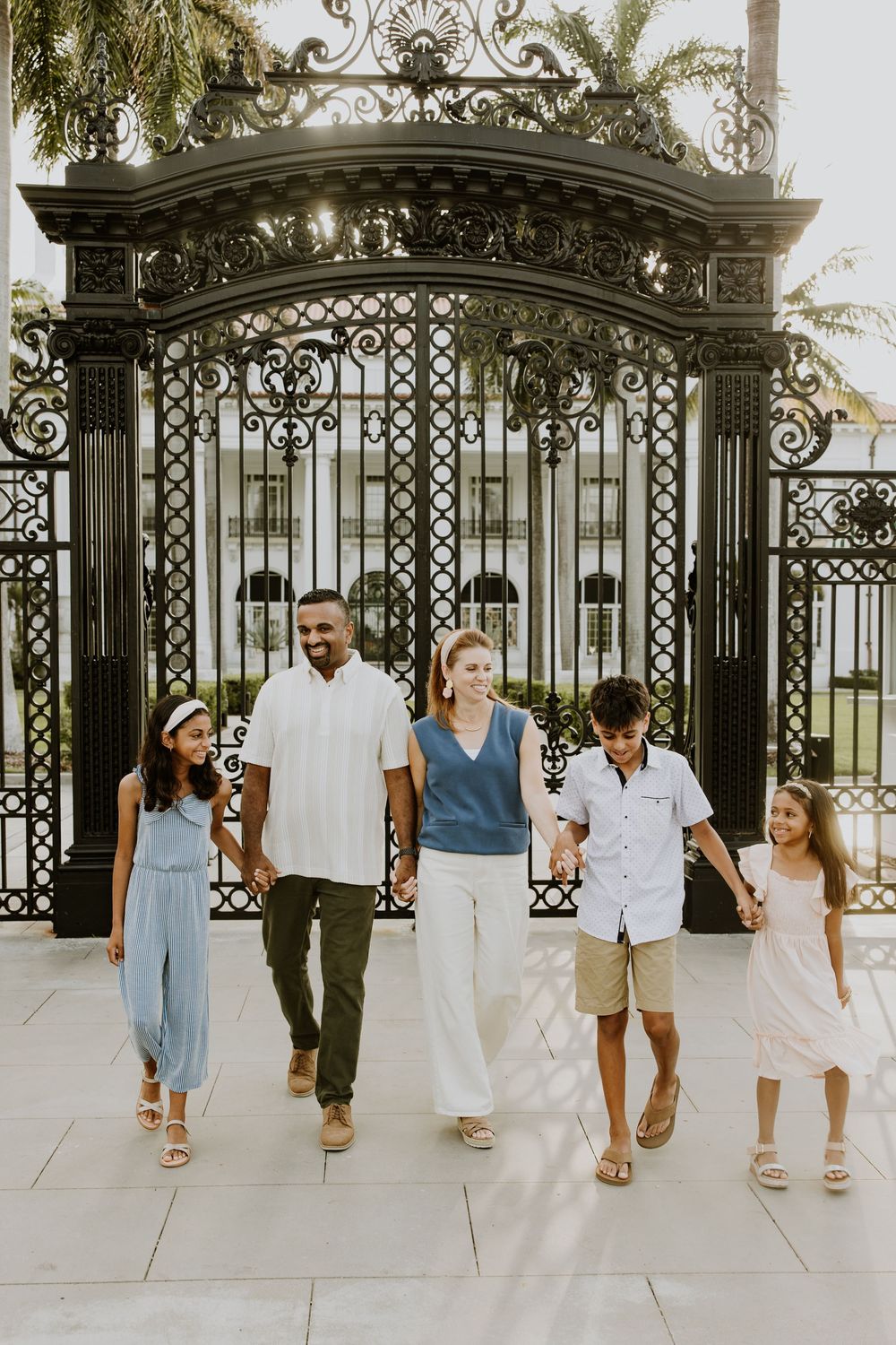 Golden hour summer family photos captured by Lindsay McDow Photography in front of Flagler Museum on Palm Beach Island