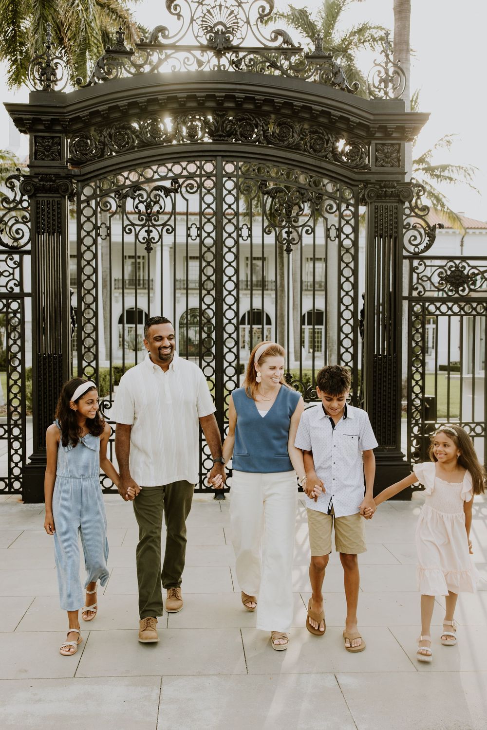 Golden hour summer family photos captured by Lindsay McDow Photography in front of Flagler Museum on Palm Beach Island