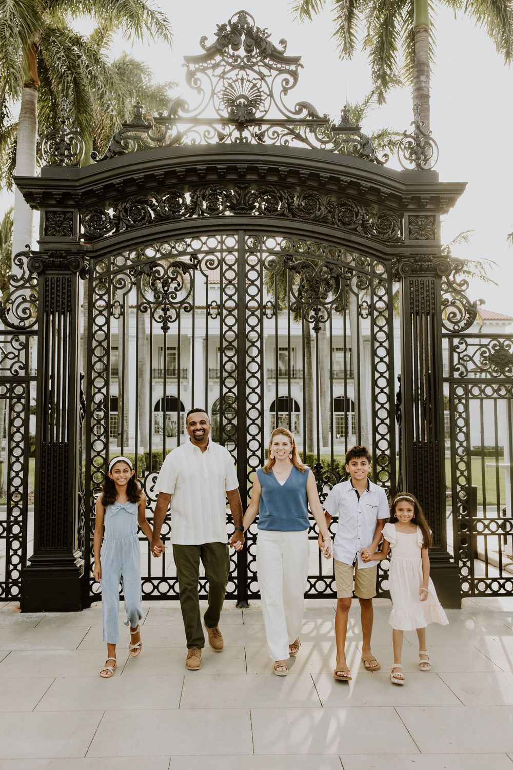 Golden hour summer family photos captured by Lindsay McDow Photography in front of Flagler Museum on Palm Beach Island