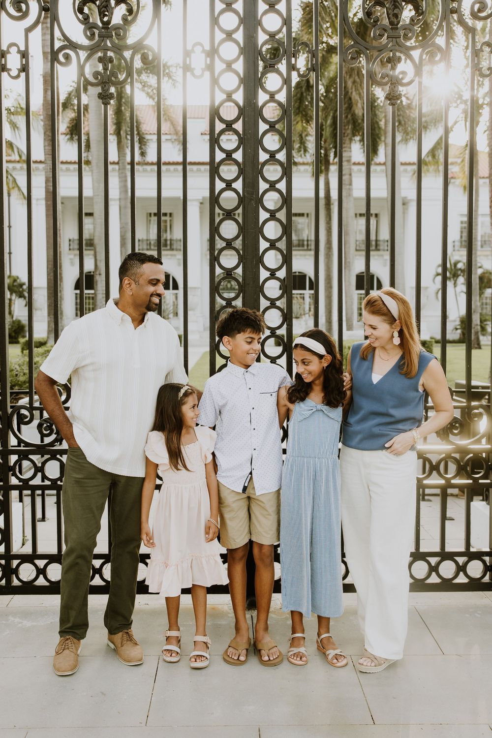 Golden hour summer family photos captured by Lindsay McDow Photography in front of Flagler Museum on Palm Beach Island