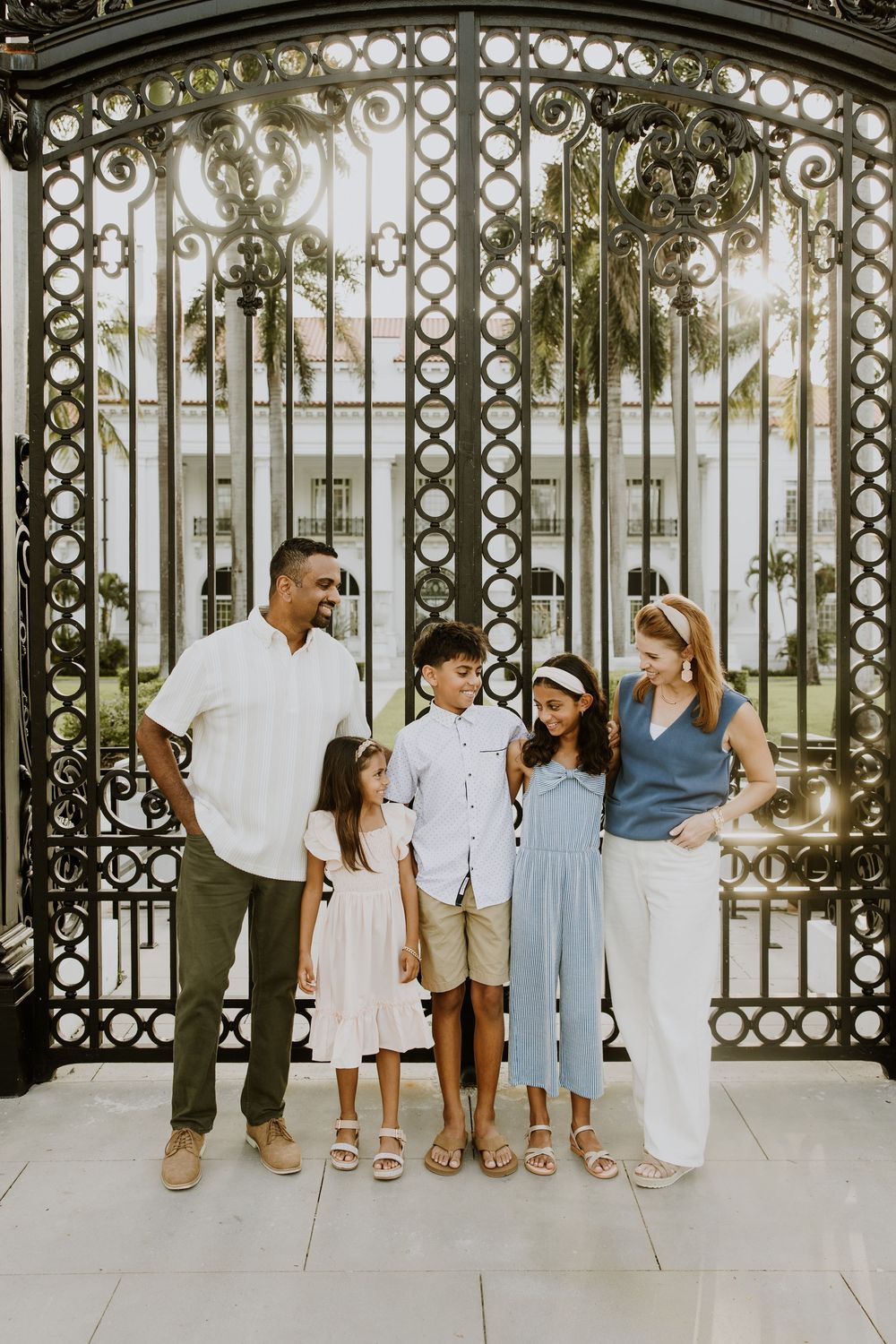 Golden hour summer family photos captured by Lindsay McDow Photography in front of Flagler Museum on Palm Beach Island