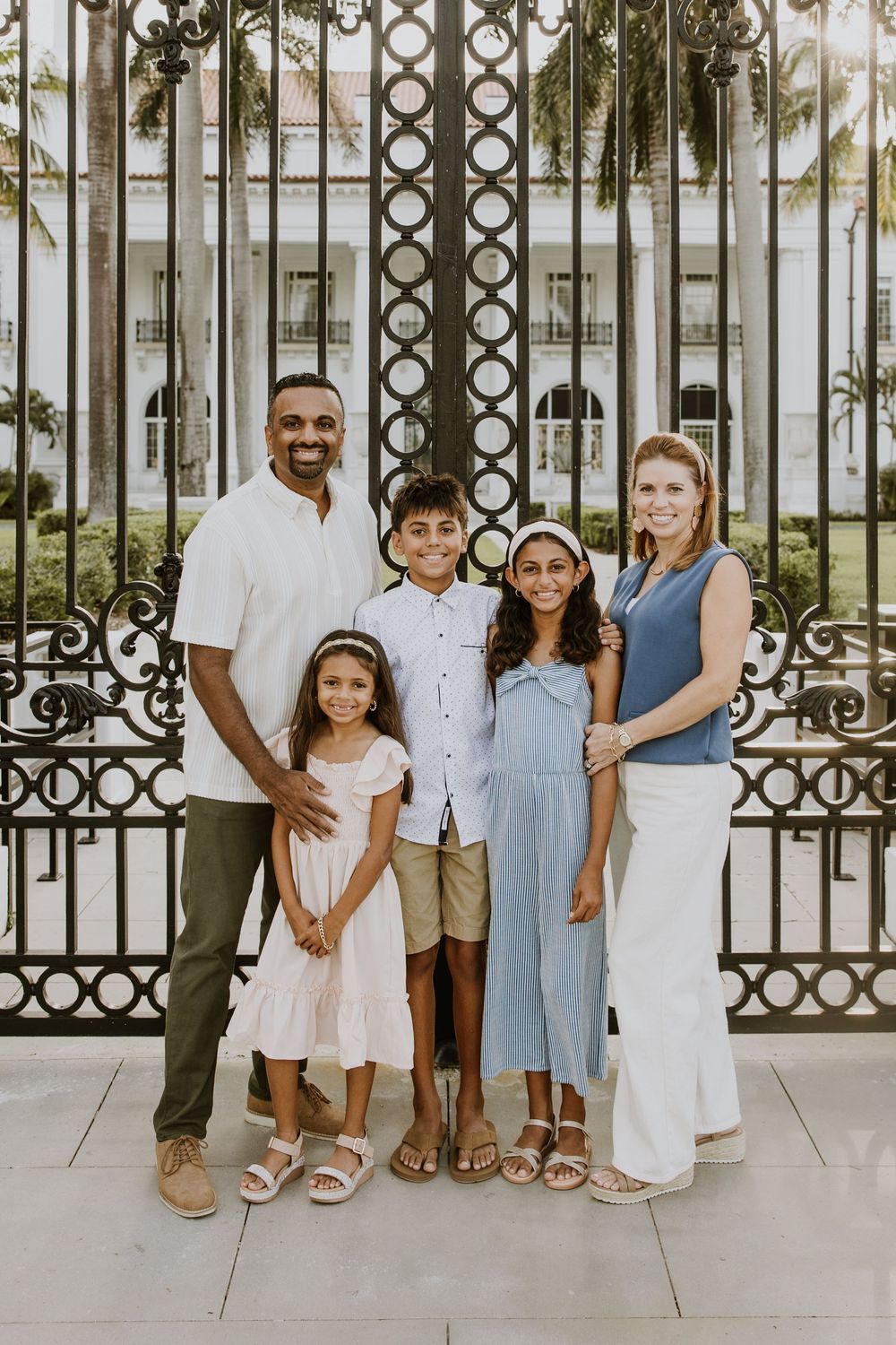 Golden hour summer family photos captured by Lindsay McDow Photography in front of Flagler Museum on Palm Beach Island