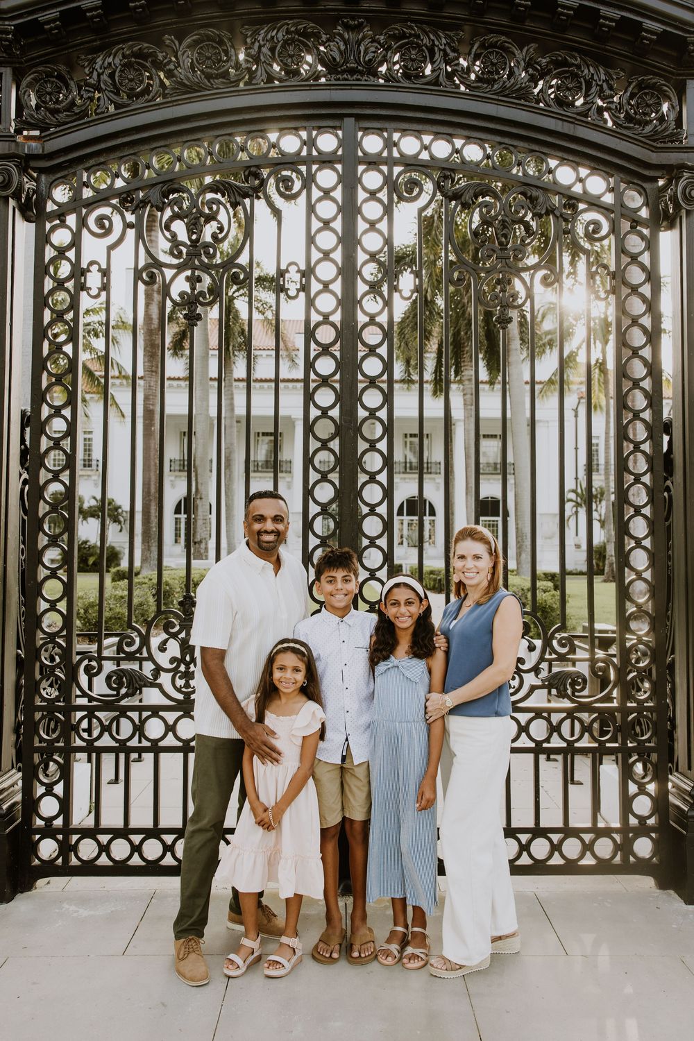Golden hour summer family photos captured by Lindsay McDow Photography in front of Flagler Museum on Palm Beach Island