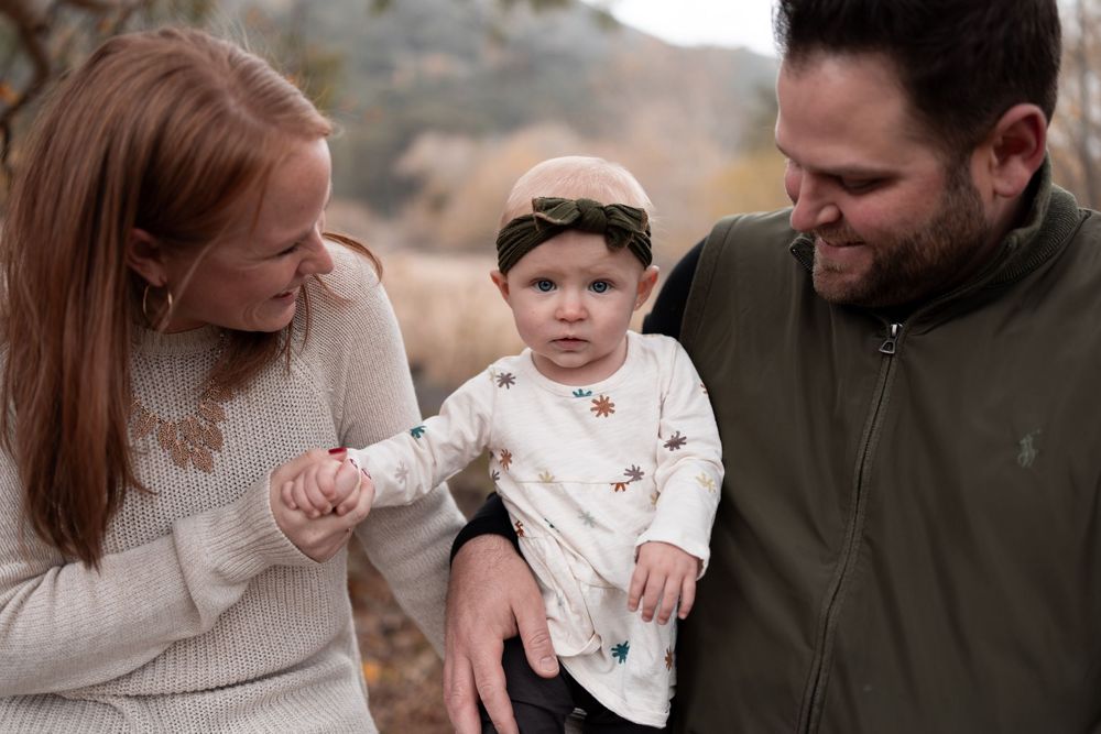 Intimate family portrait session captured in natural outdoor lighting.