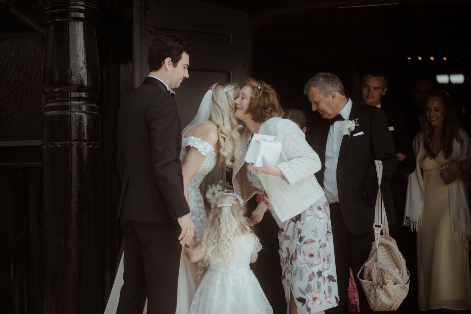 Candid wedding reception moment showing guests and wedding party interacting.