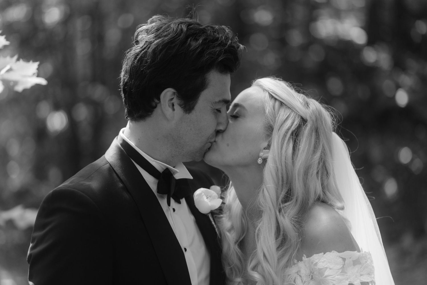 An intimate wedding portrait showing a tender moment between newlyweds.