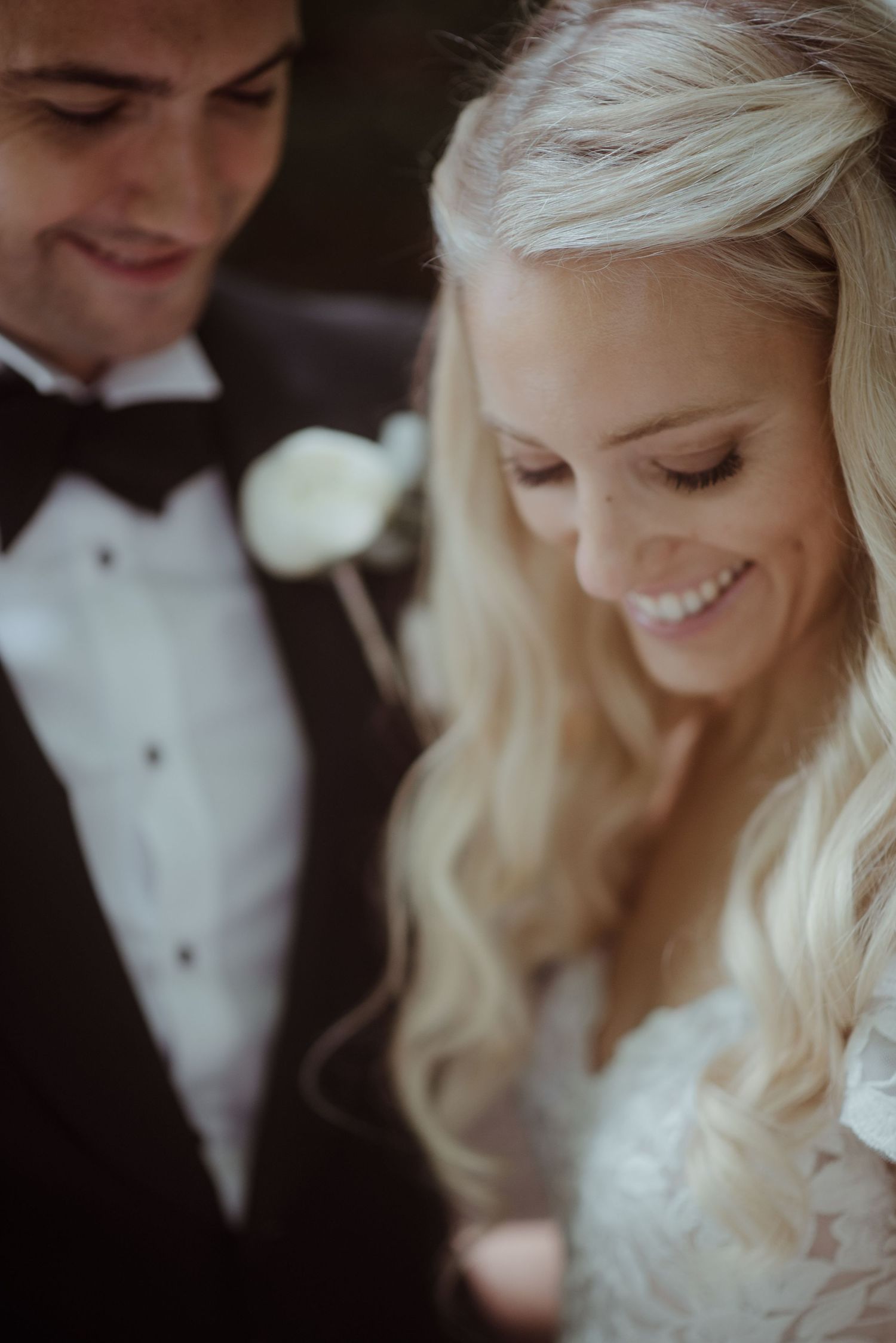 A joyful wedding moment captured in warm tones with elegant formal attire.
