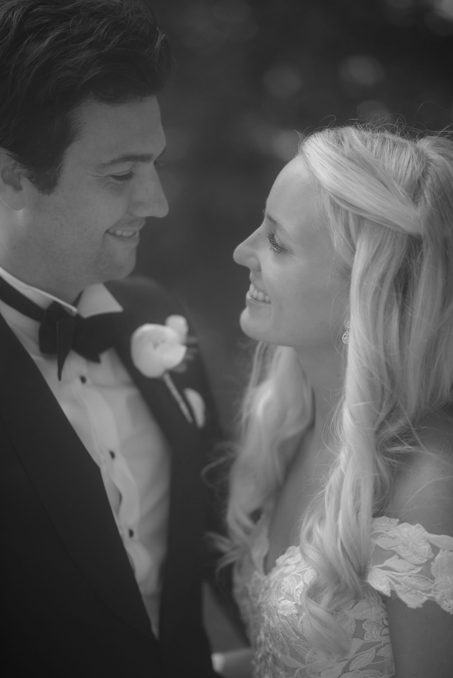 A candid black and white portrait showing genuine happiness between newlyweds.