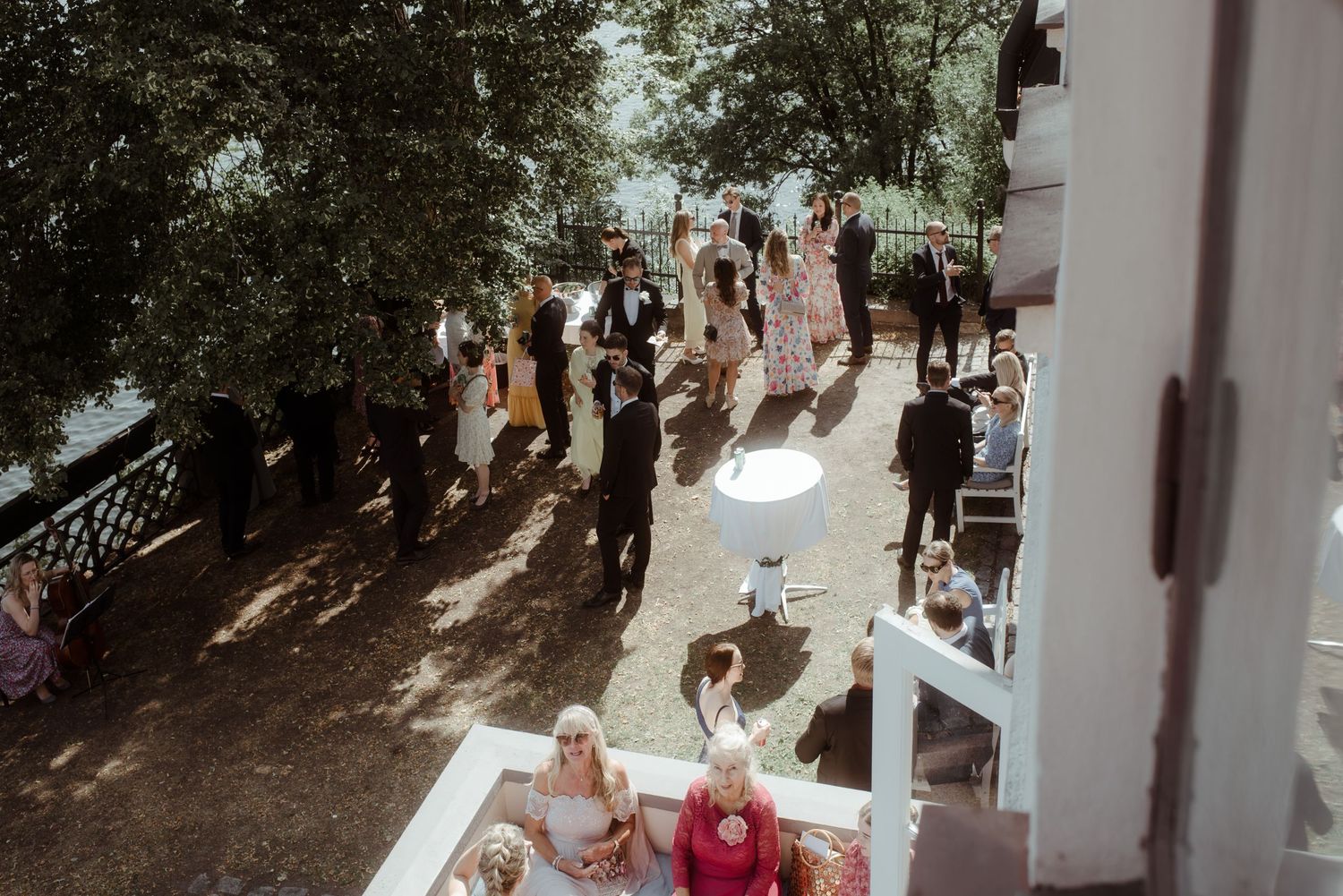 Aerial view of wedding guests gathered on an outdoor terrace.