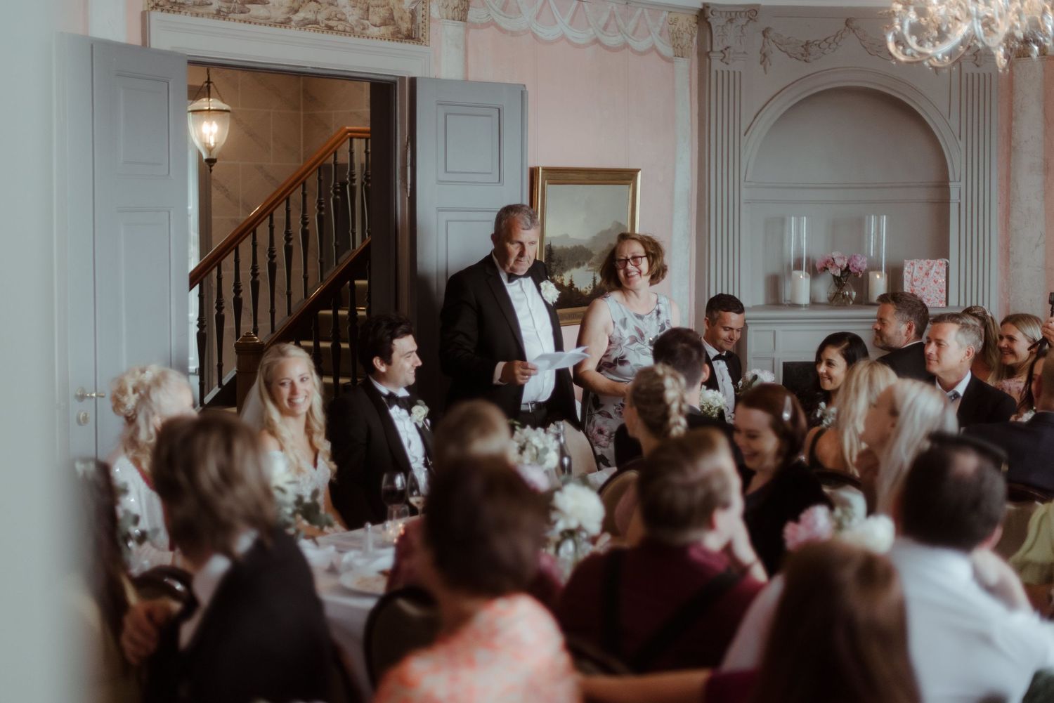 Guests gathered in a formal dining room for an elegant celebration.