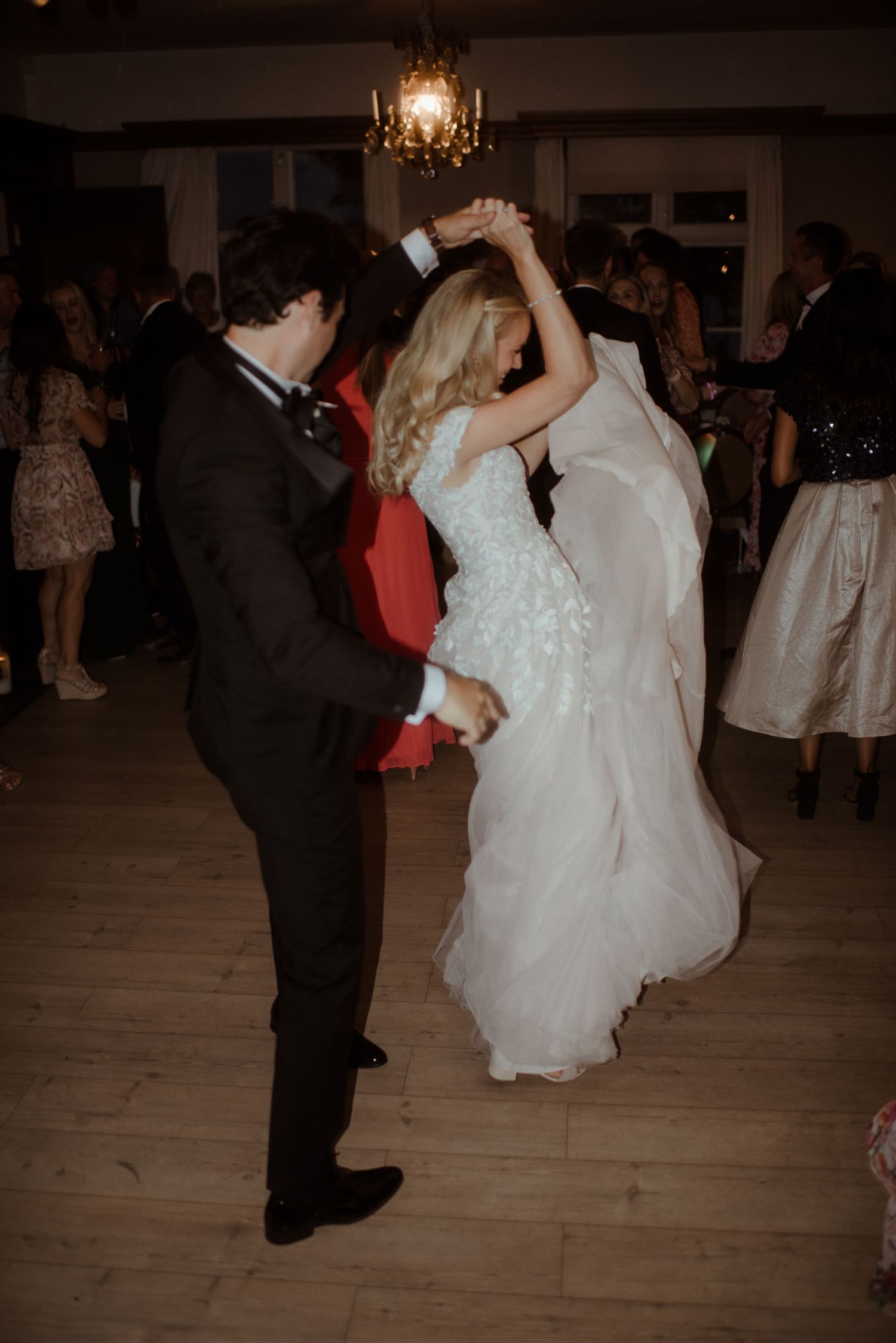 A couple spins and dances together during their wedding reception celebration.