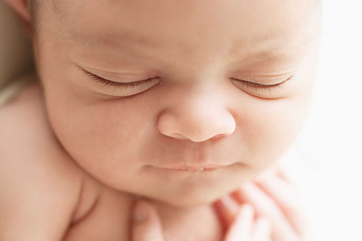 Peaceful sleeping newborn close-up portrait.