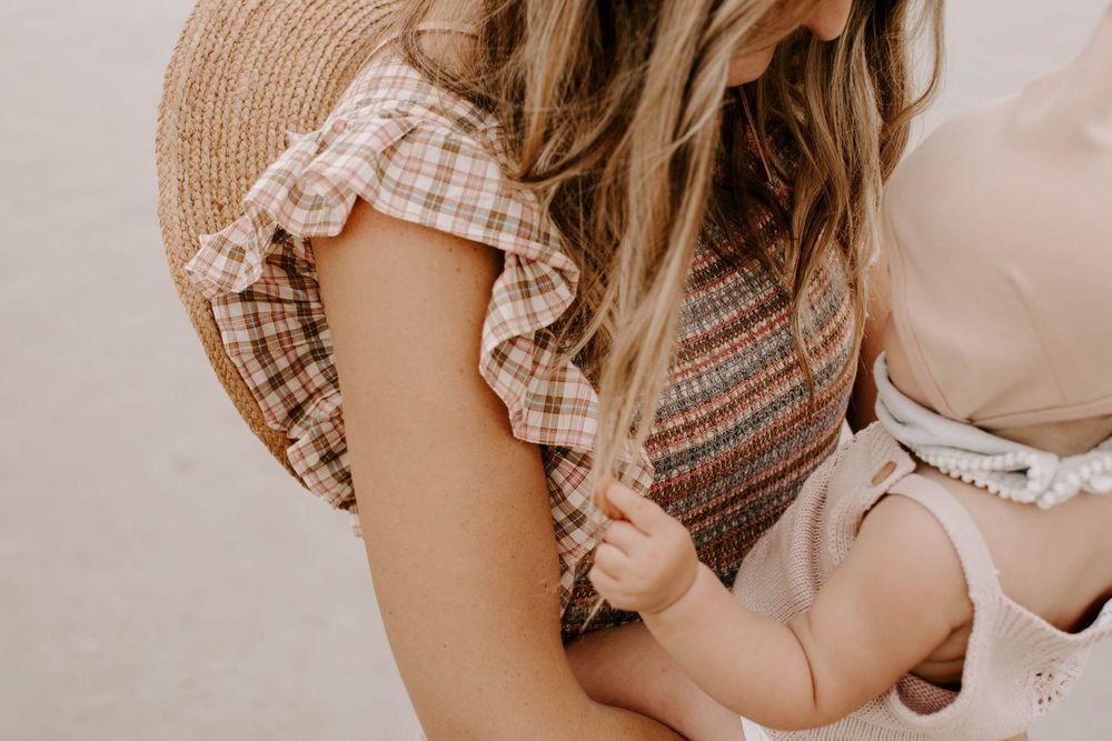 Parent and child share playful loving moments together at the beach.