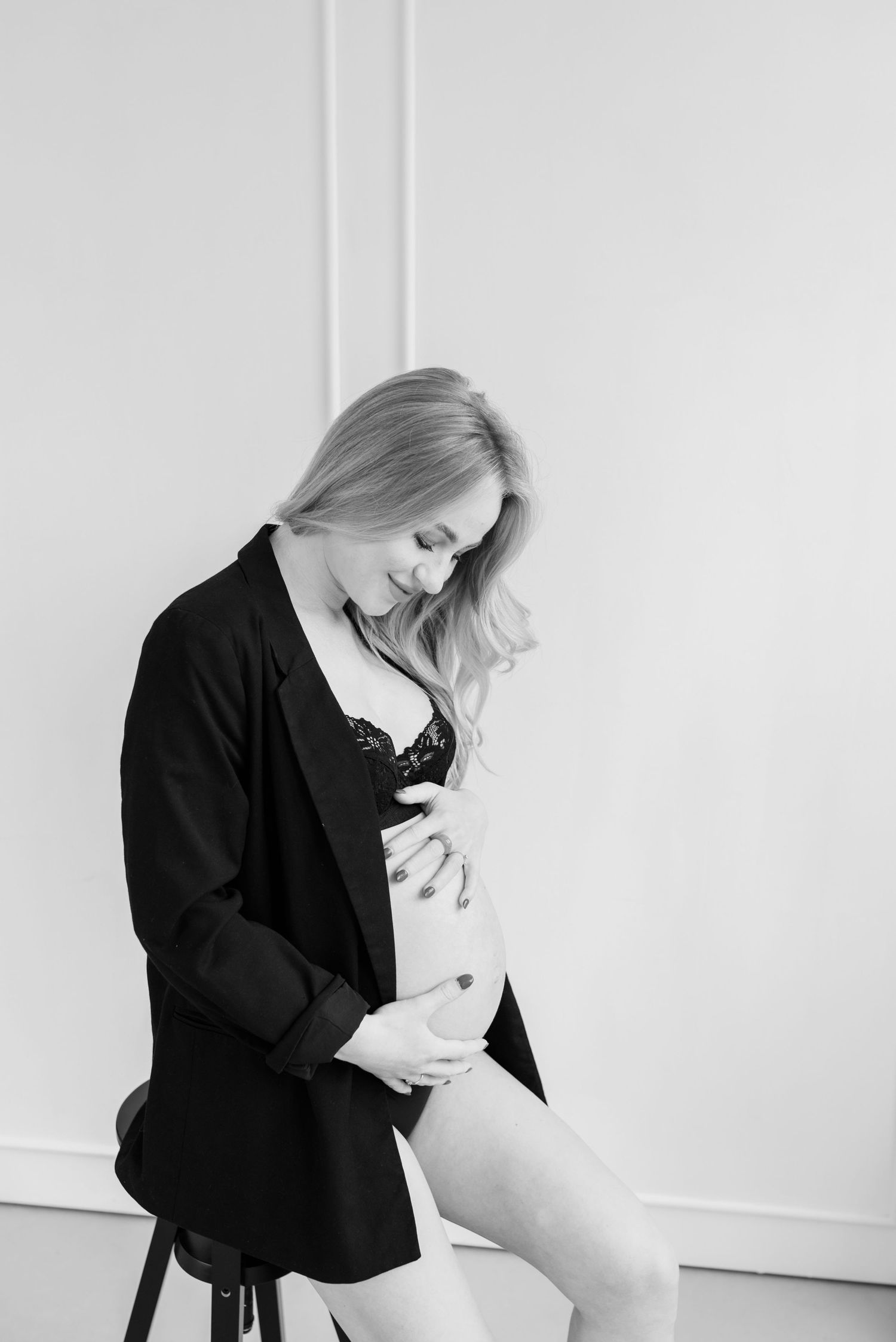 Black and white photo series showing tender moments of a figure in dark clothing against a white background.
