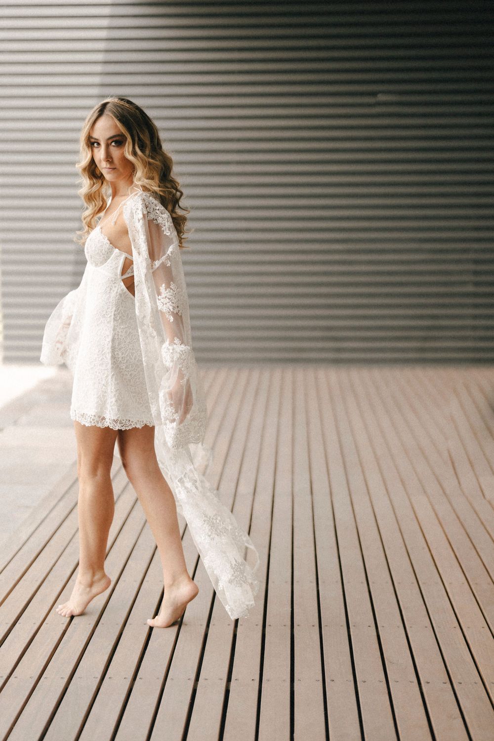 A series of elegant photos showing white lace dress details and bare feet walking across wooden decking.