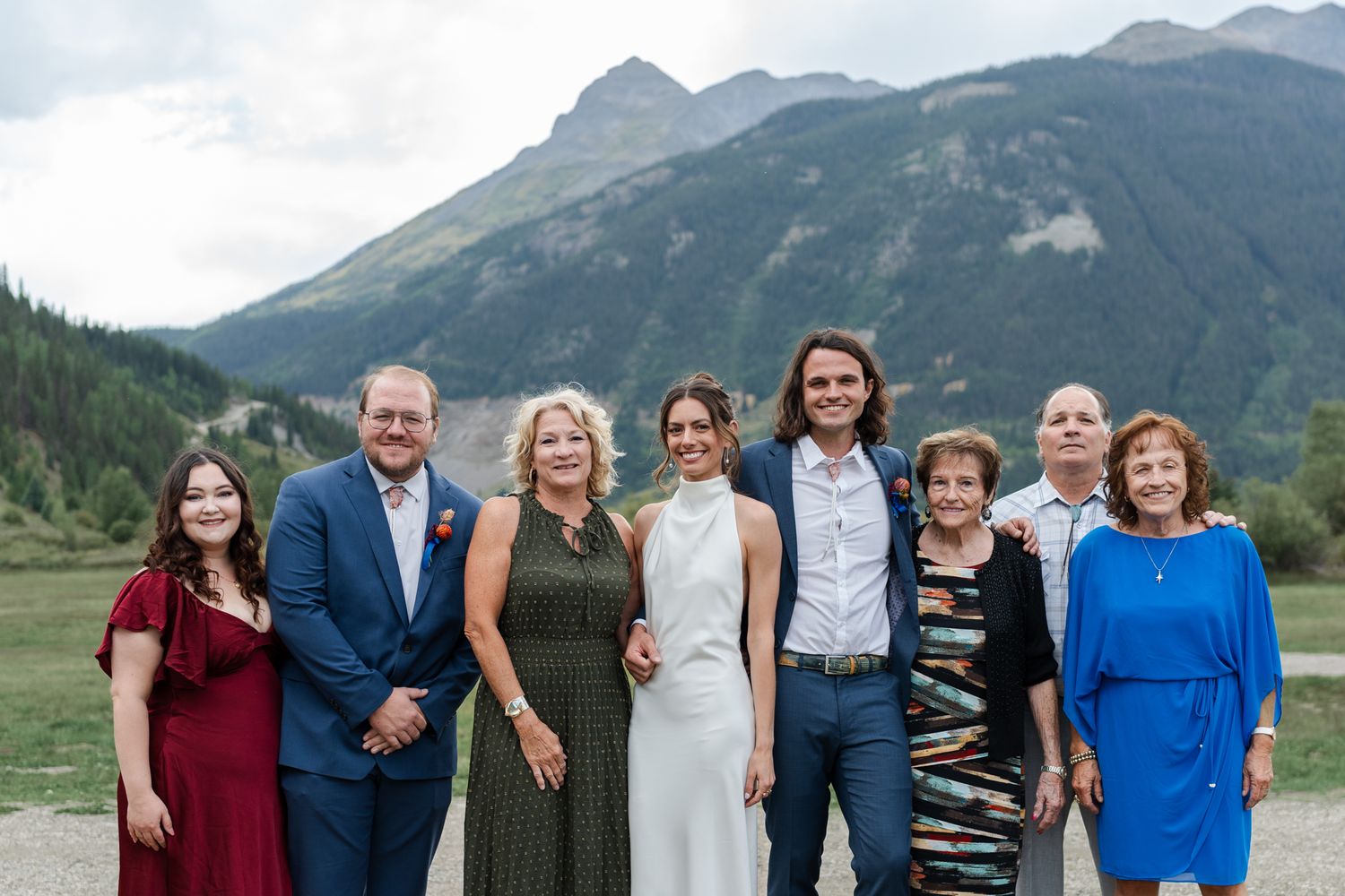 Wedding party group poses against stunning mountain backdrop in Colorado.